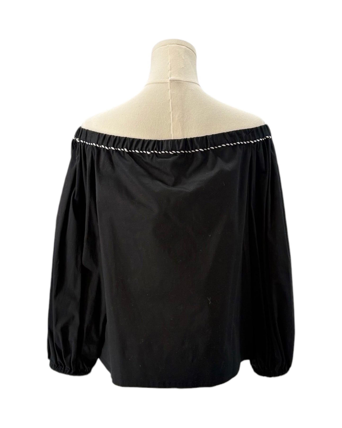 Black off-shoulder blouse on a mannequin with a white background