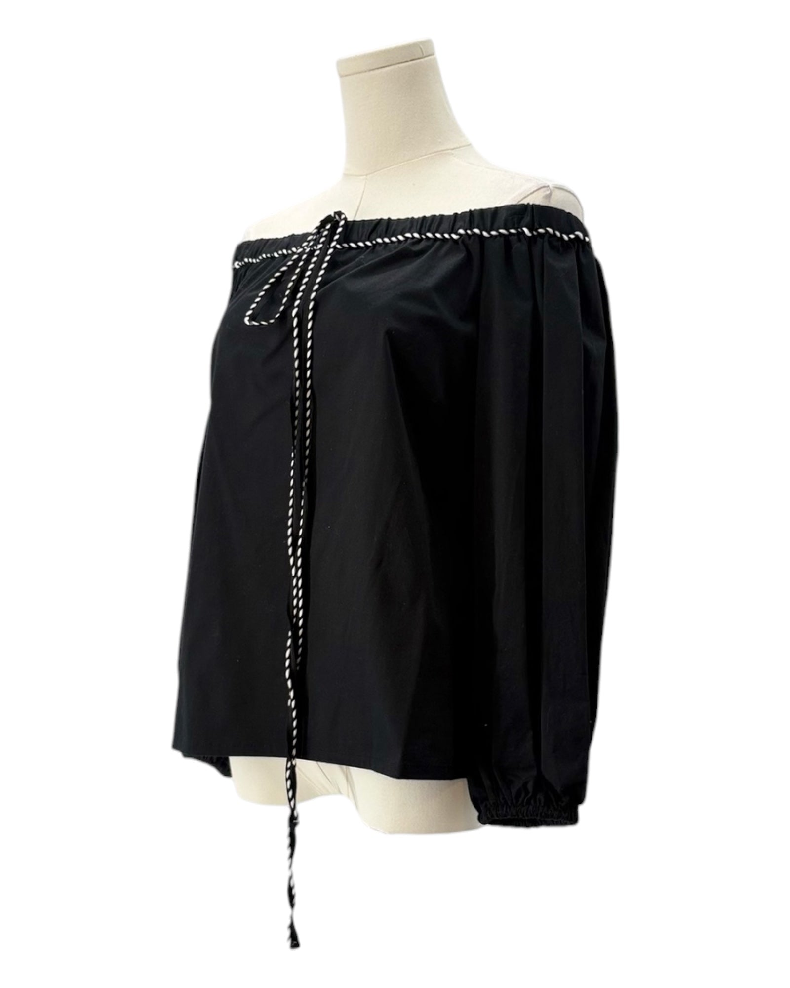 Black off-shoulder top with pearl details on a mannequin against a white background