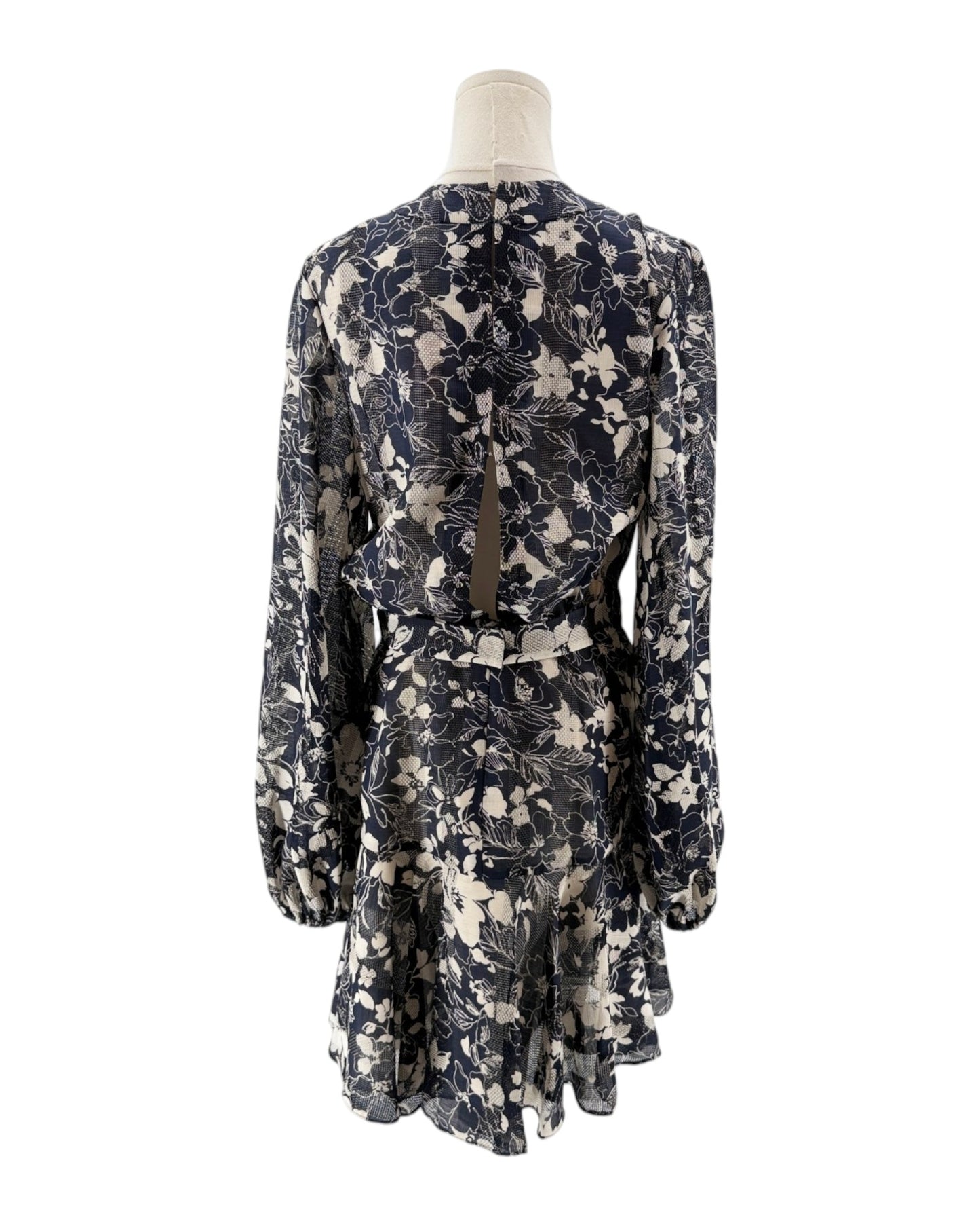 Floral patterned dress on a mannequin against a white background