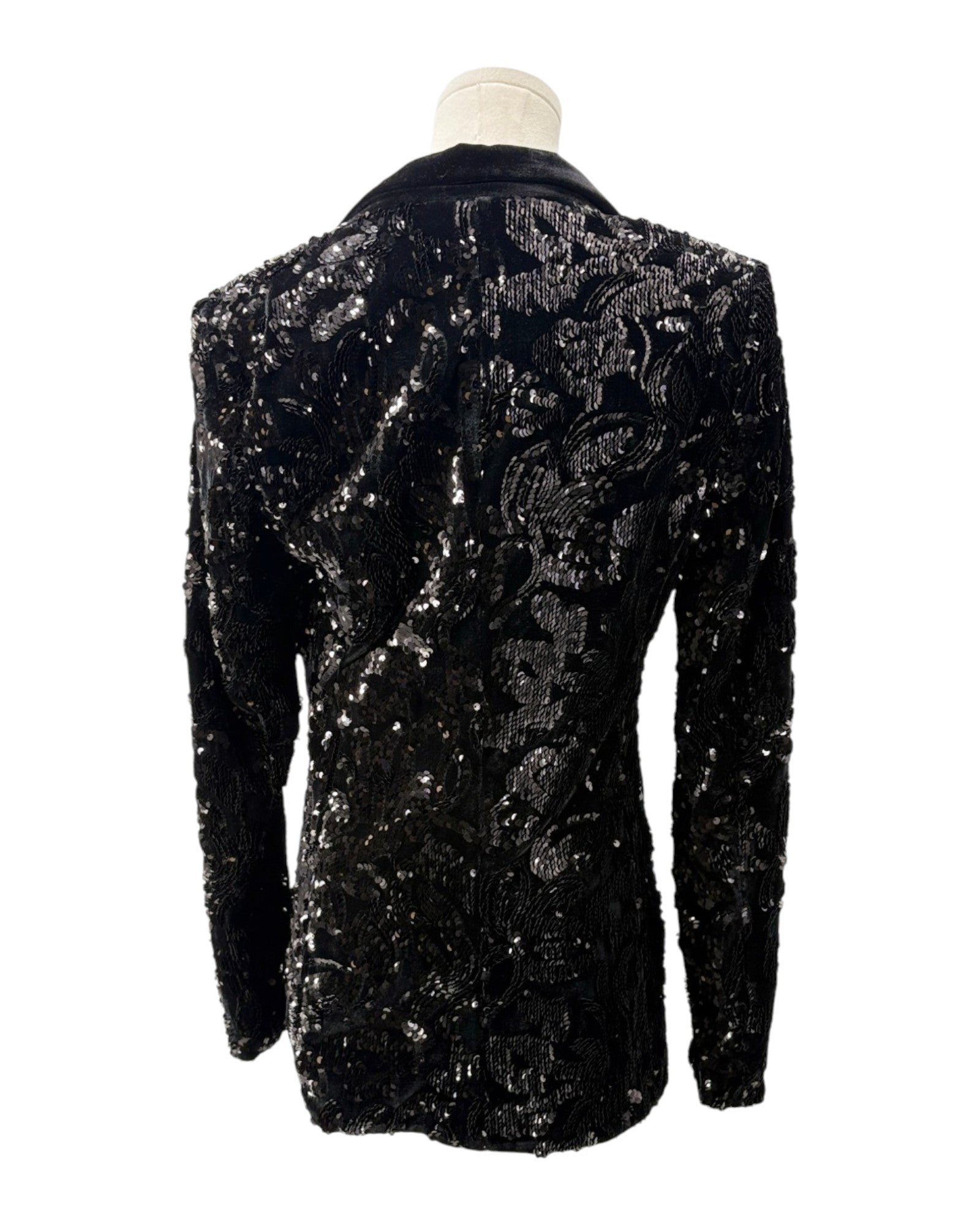 Black sequined jacket on a mannequin against a white background