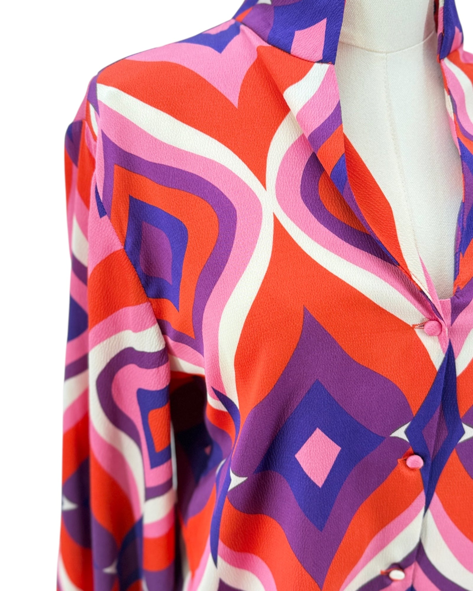 Colorful patterned shirt on a mannequin against a white background