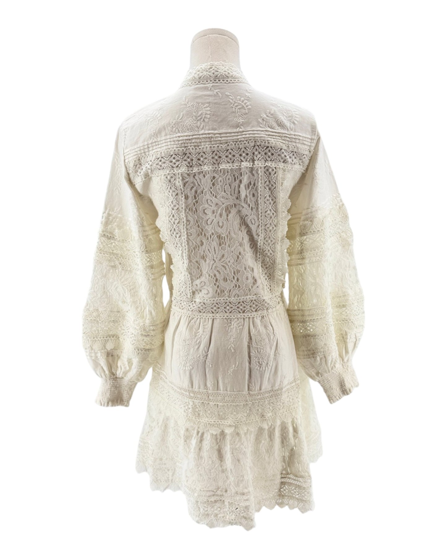 White lace dress on a mannequin against a white background