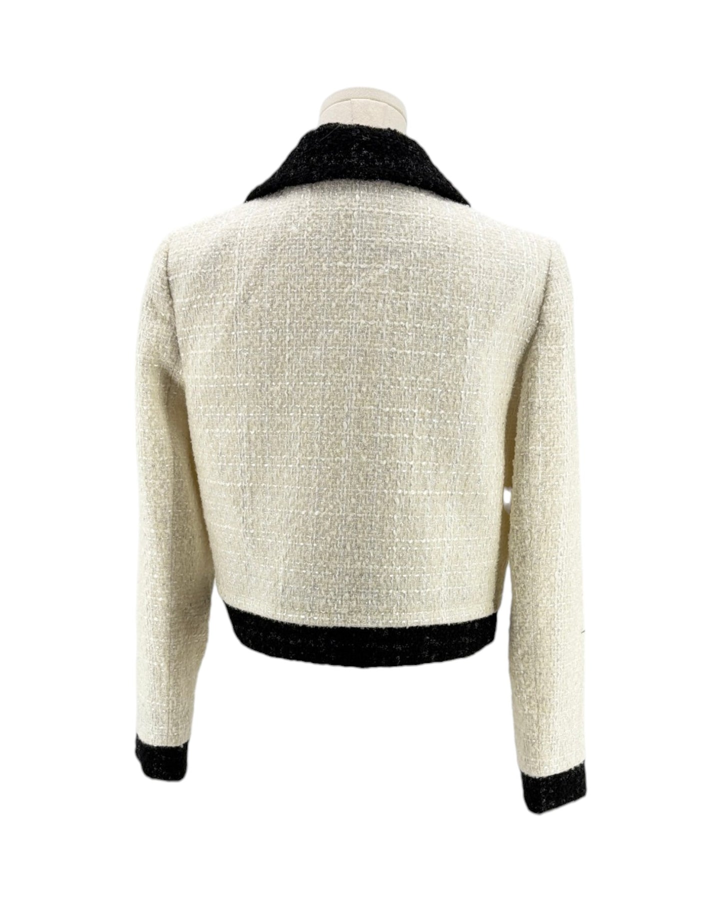Back view of a white textured jacket with black trim on a white background