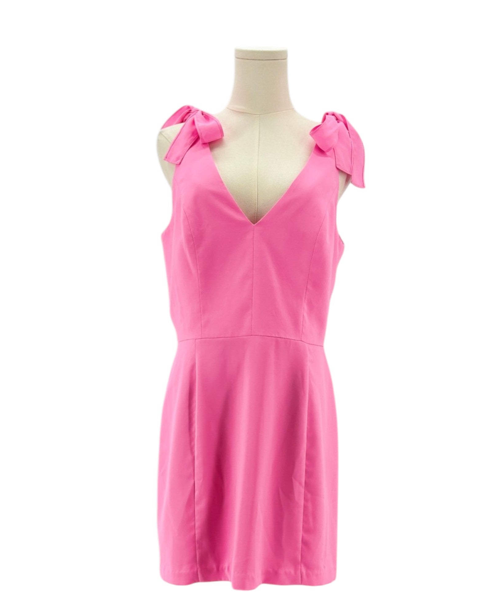 Amanda Uprichard pink dress on a mannequin with bow details against a white background