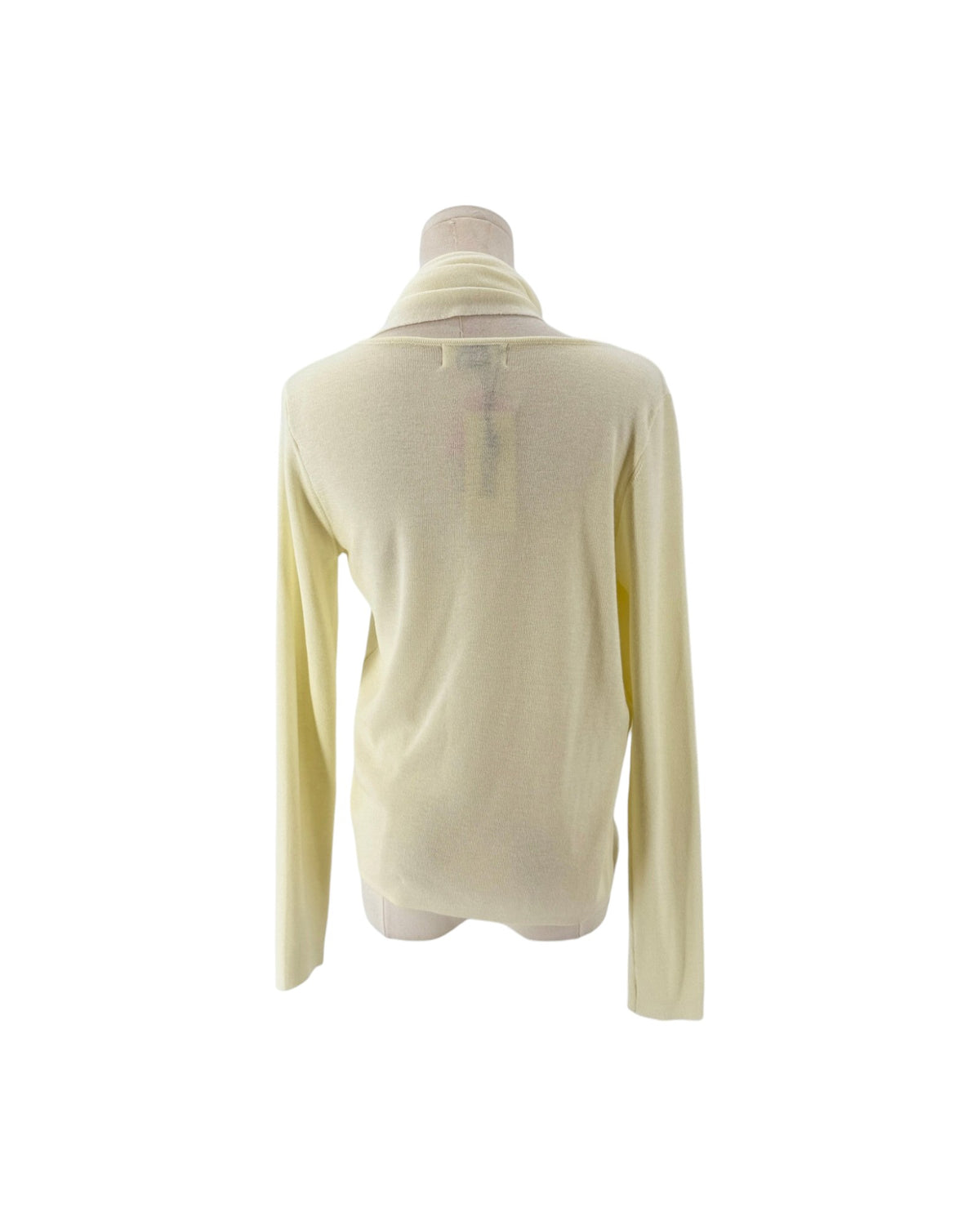 Long sleeve cream sweater with built in scarf neckline on a mannequin on a white background