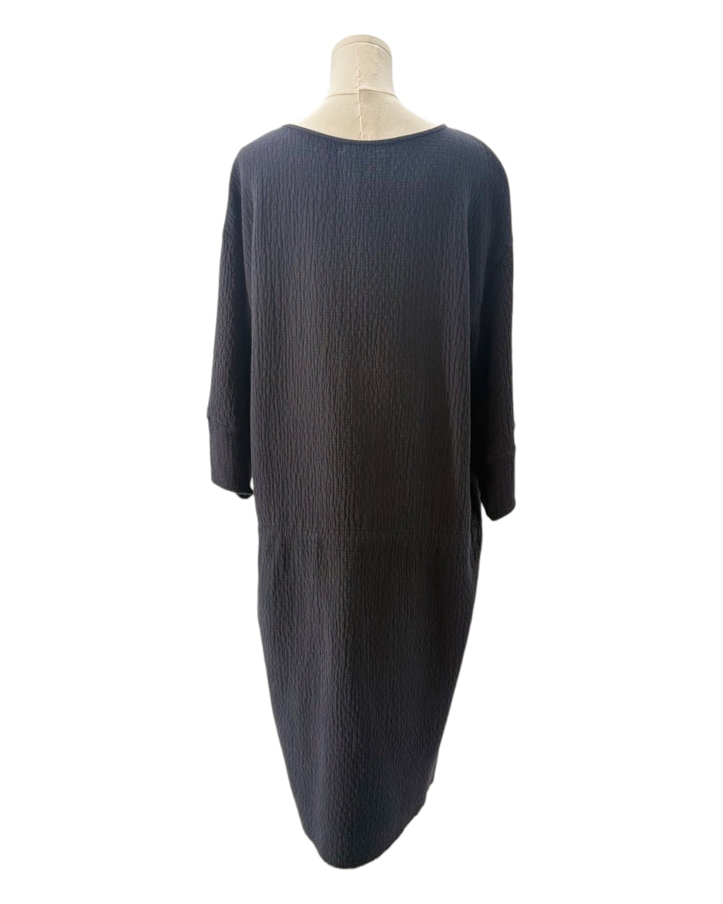 Black dress on a mannequin against a white background