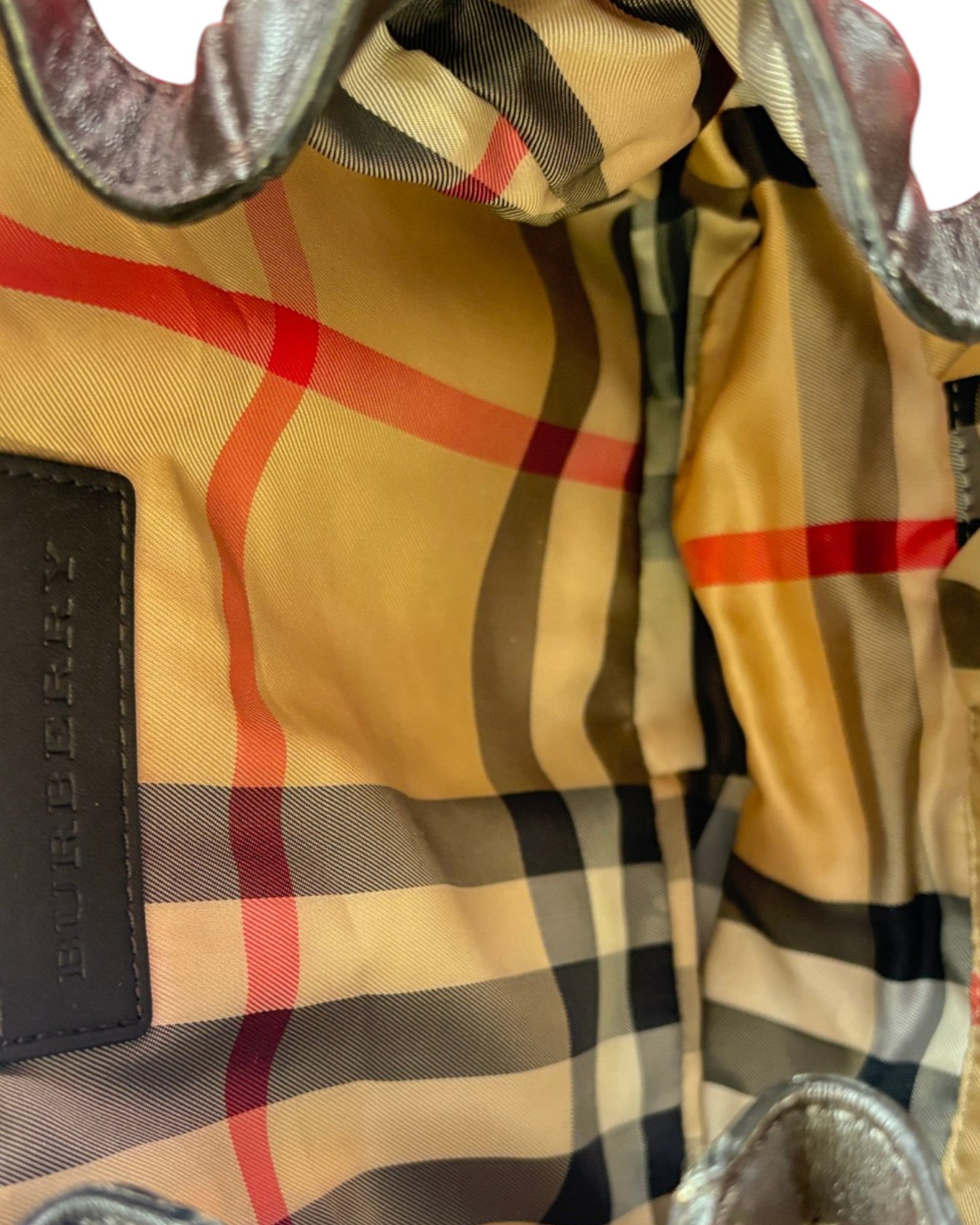 Close-up of a checkered fabric with visible Burberry logo.