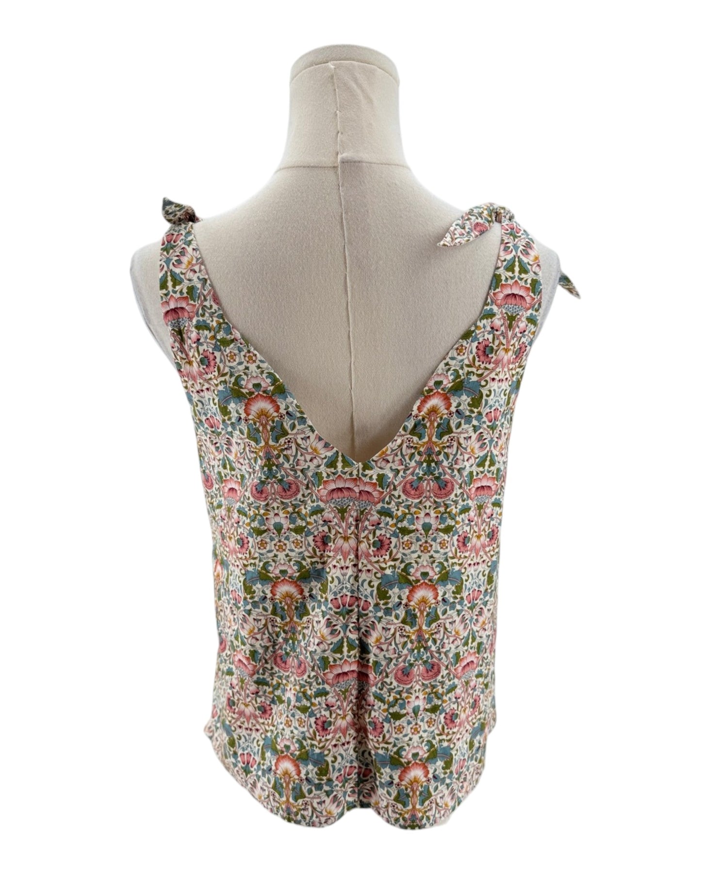 Floral patterned sleeveless top on a mannequin against a white background