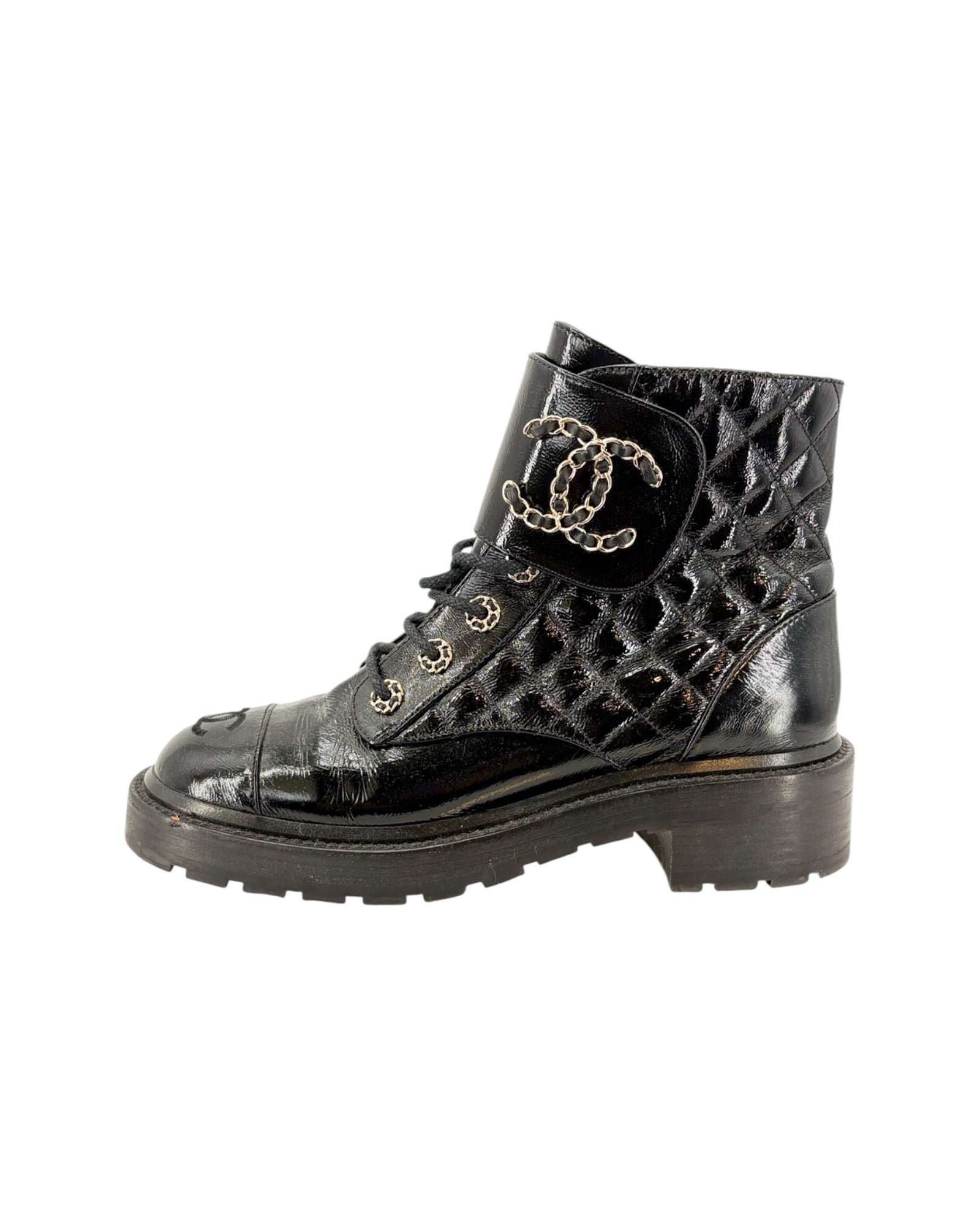 Black ankle boot with a brand logo on a white background