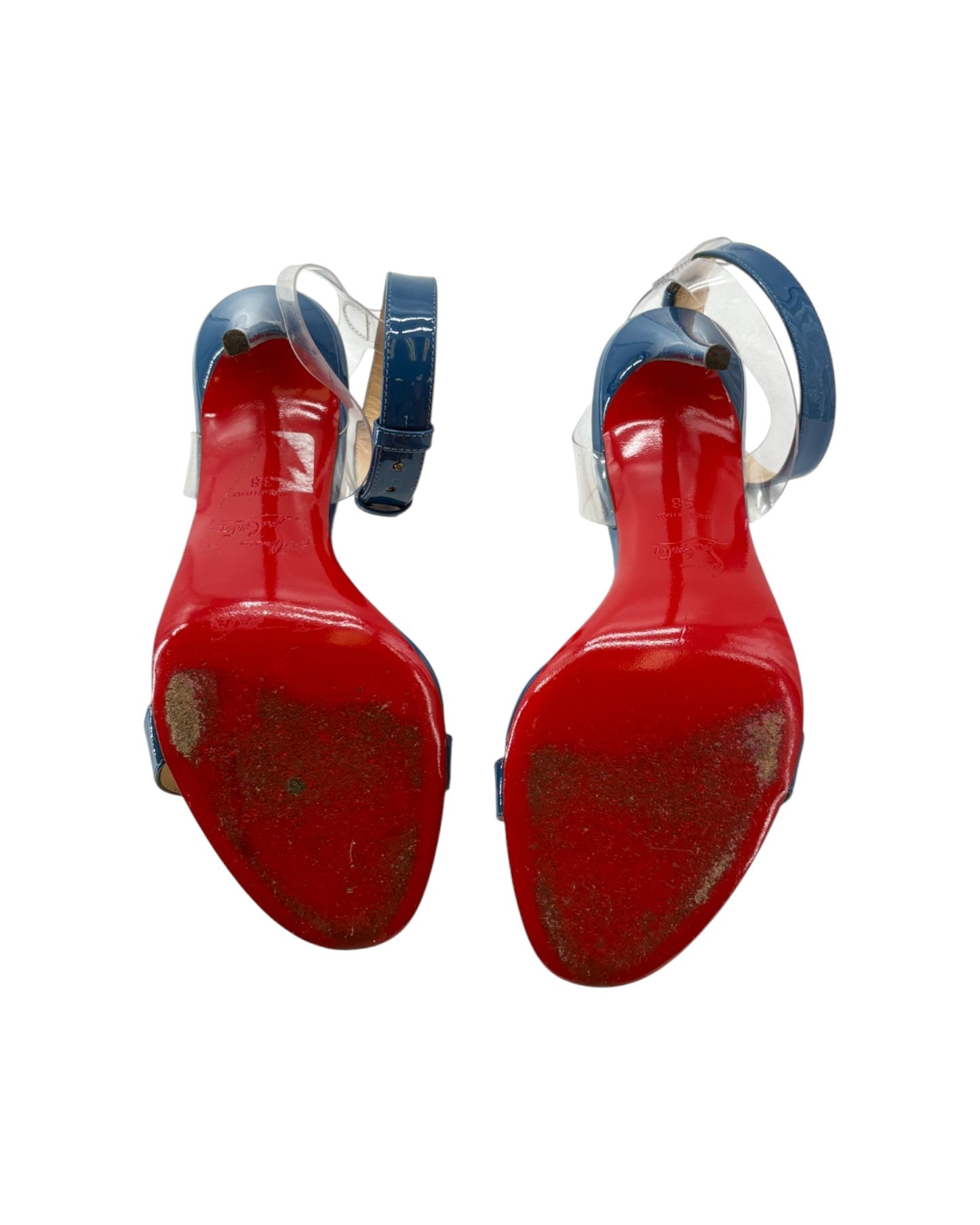 Red bottom high-heeled shoes with blue straps on a white background