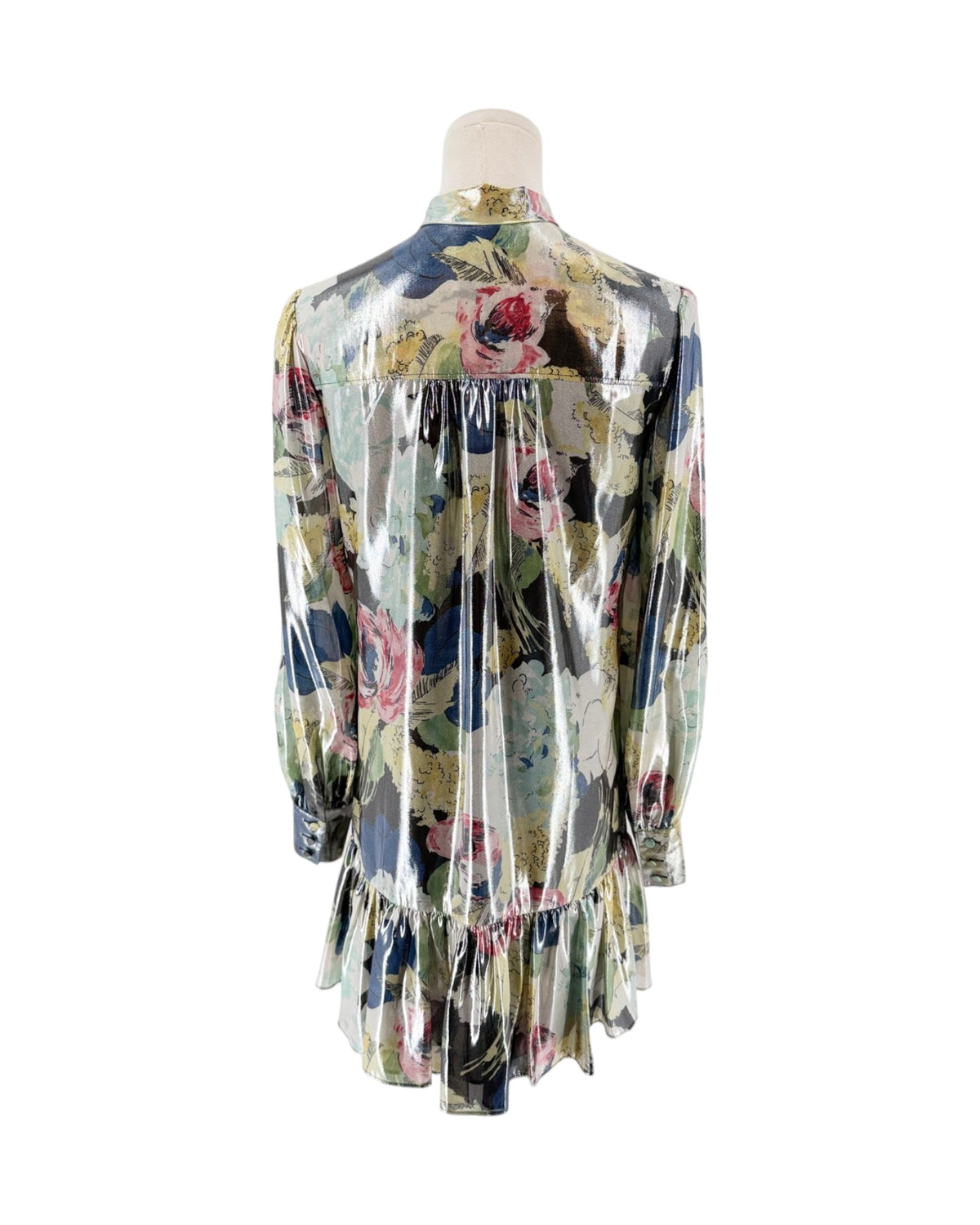 A long-sleeve satin dress with a floral print, shown from the back on a mannequin. The glossy fabric features a mix of pink, blue, green, and yellow floral motifs over a light base.