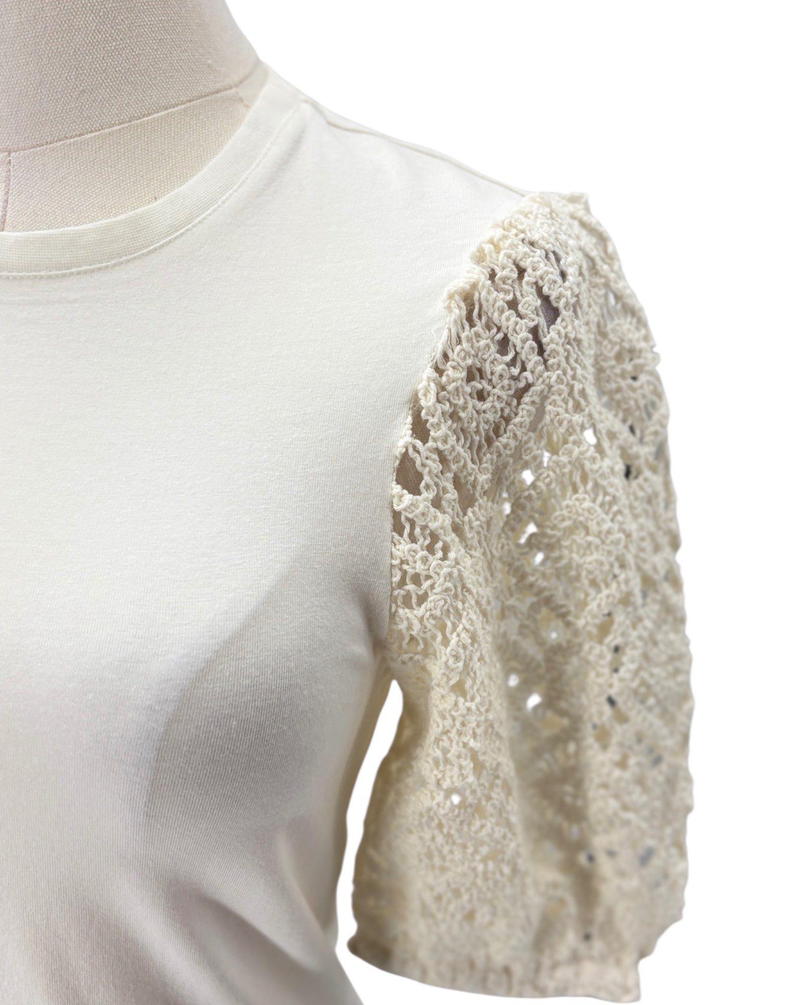 White blouse with lace sleeves on a mannequin