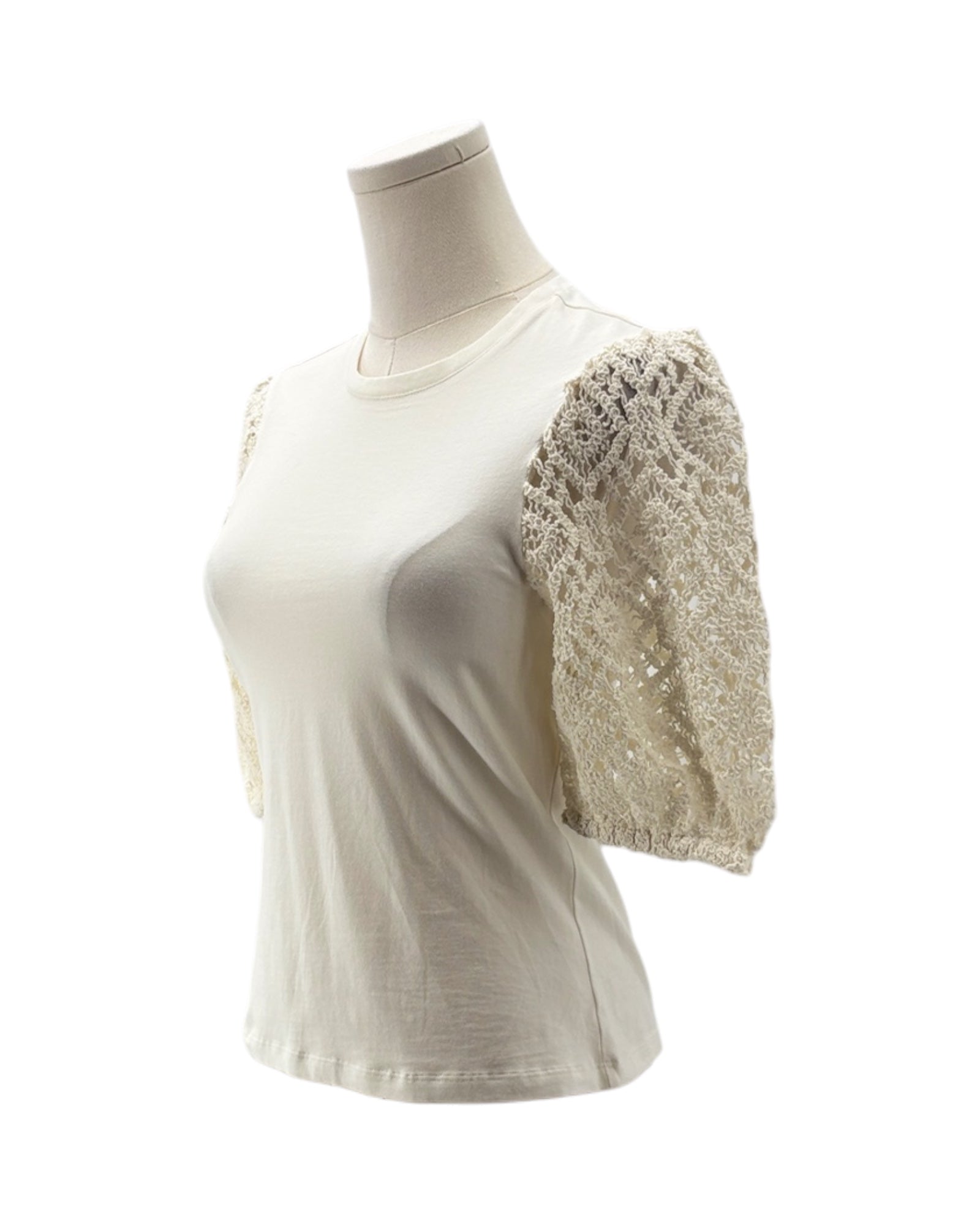 White t-shirt with lace sleeves on a mannequin against a white background