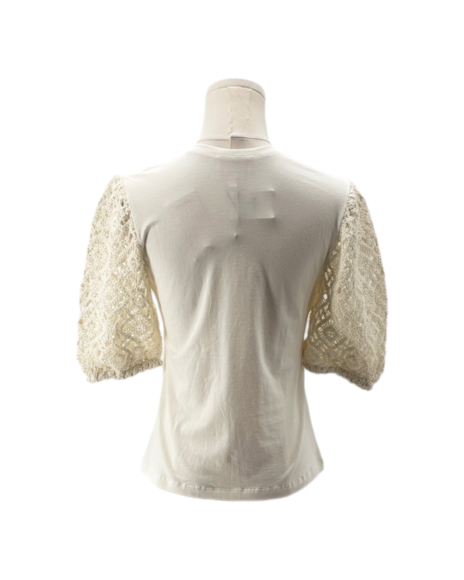 White blouse with lace sleeves on a mannequin against a white background