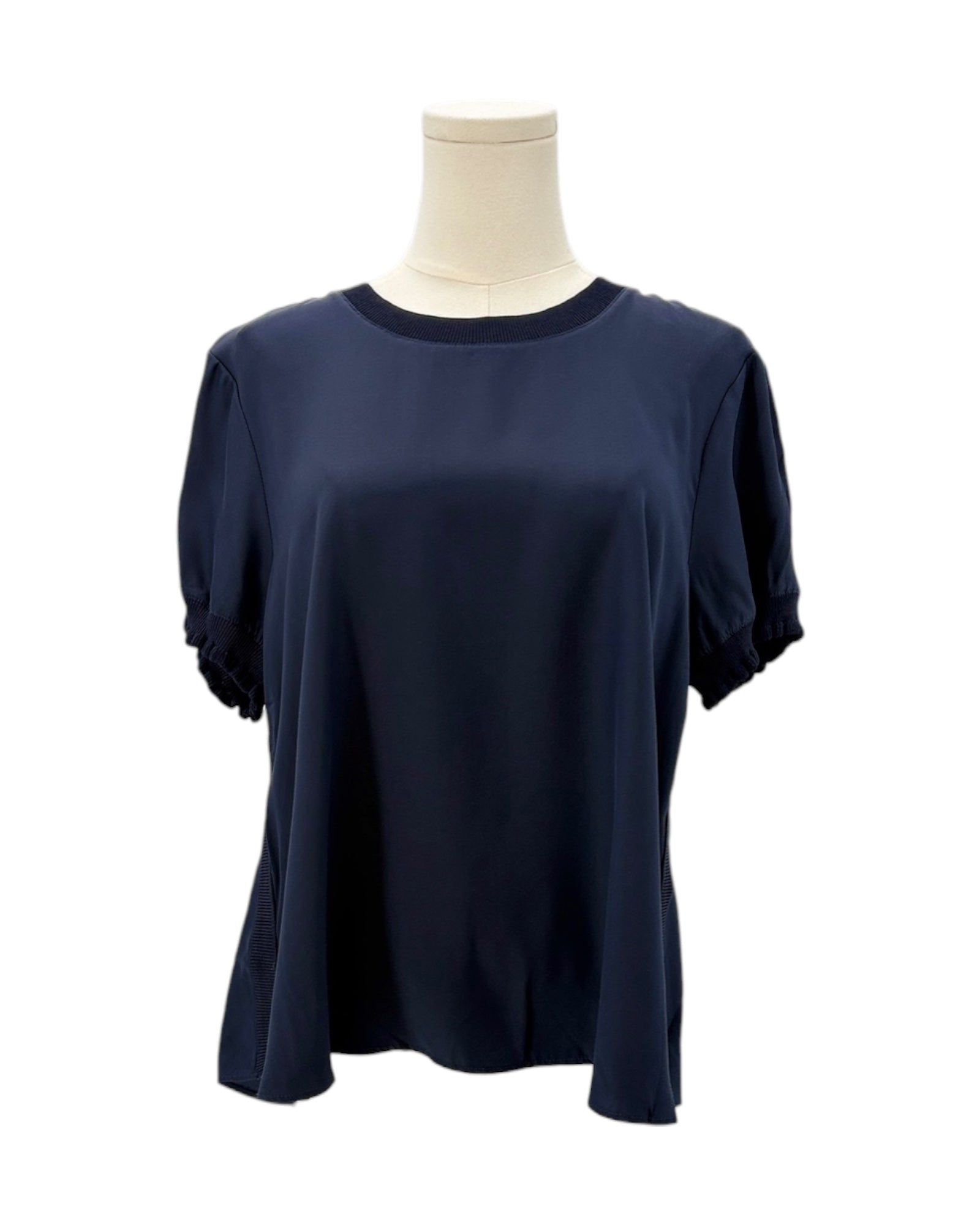 Cinq a Sept navy blue silk shirt on a mannequin against a white background