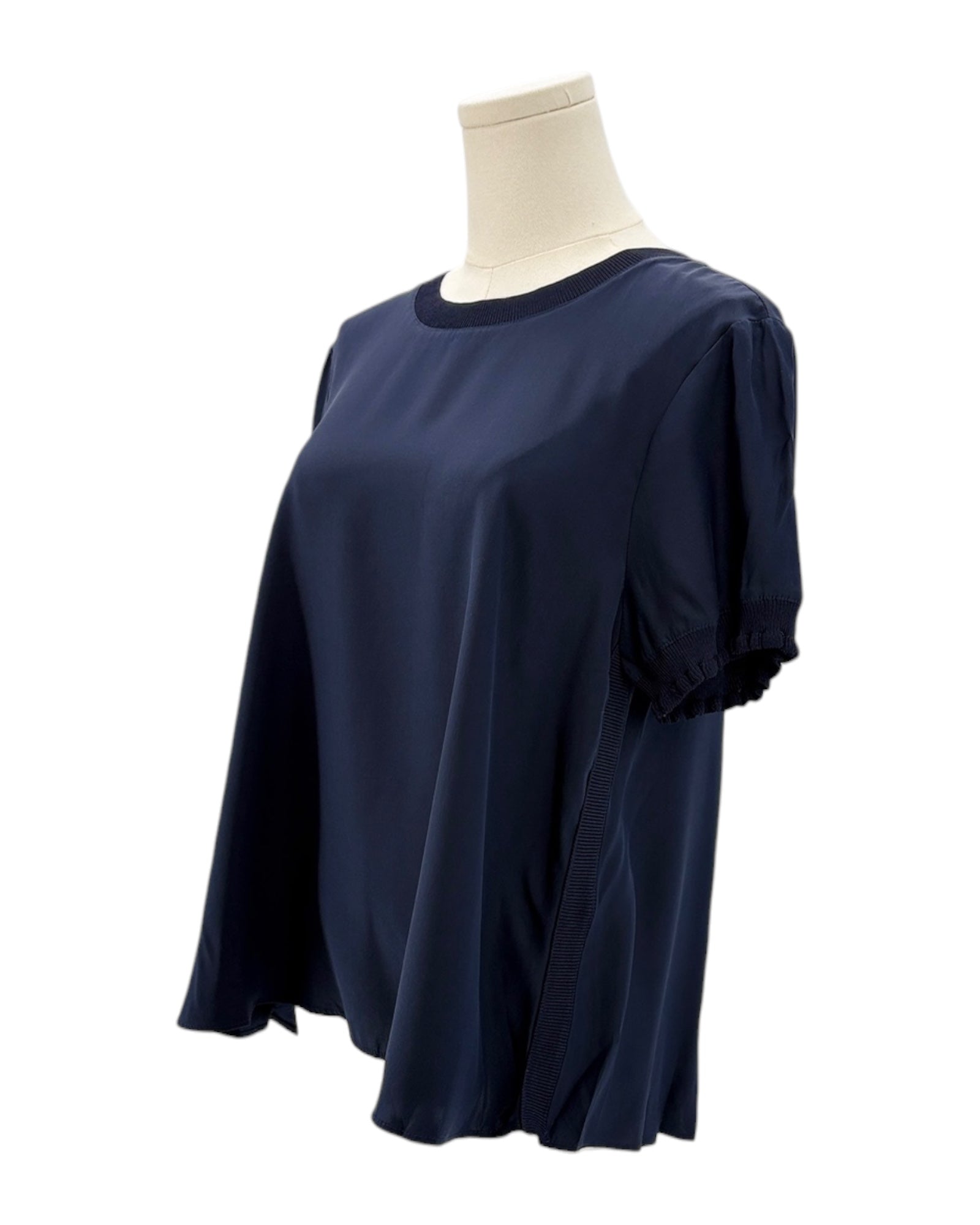 Cinq a Sept navy blue silk shirt on a mannequin against a white background