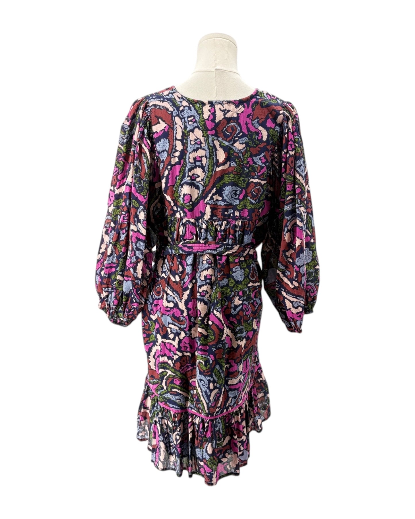 Colorful patterned dress on a mannequin against a white background