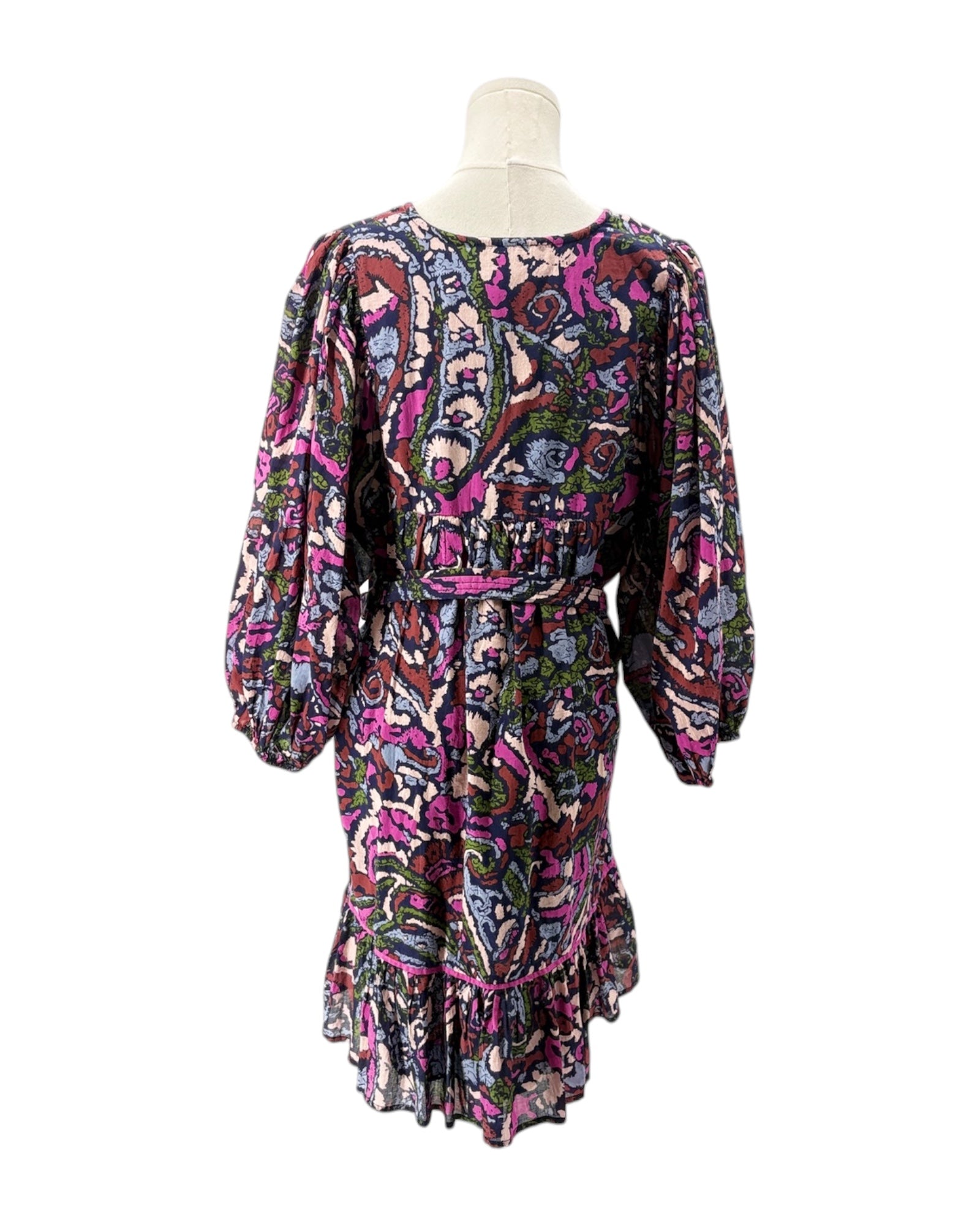 Colorful patterned dress on a mannequin against a white background