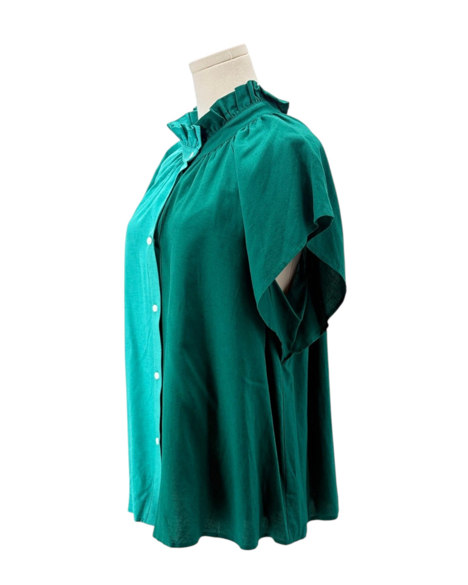 Green dress on a mannequin against a white background