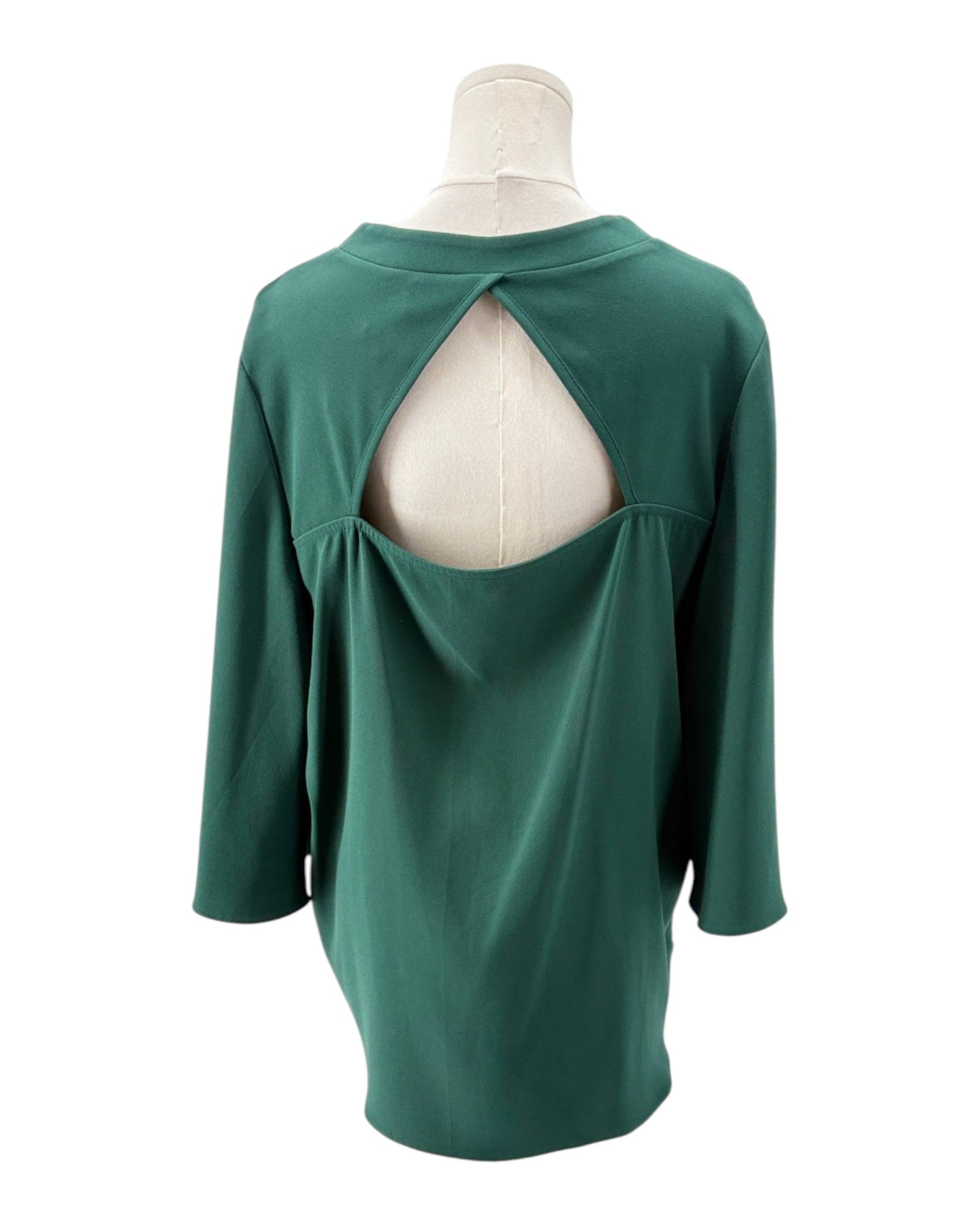 Green long-sleeve top on a mannequin with a white background