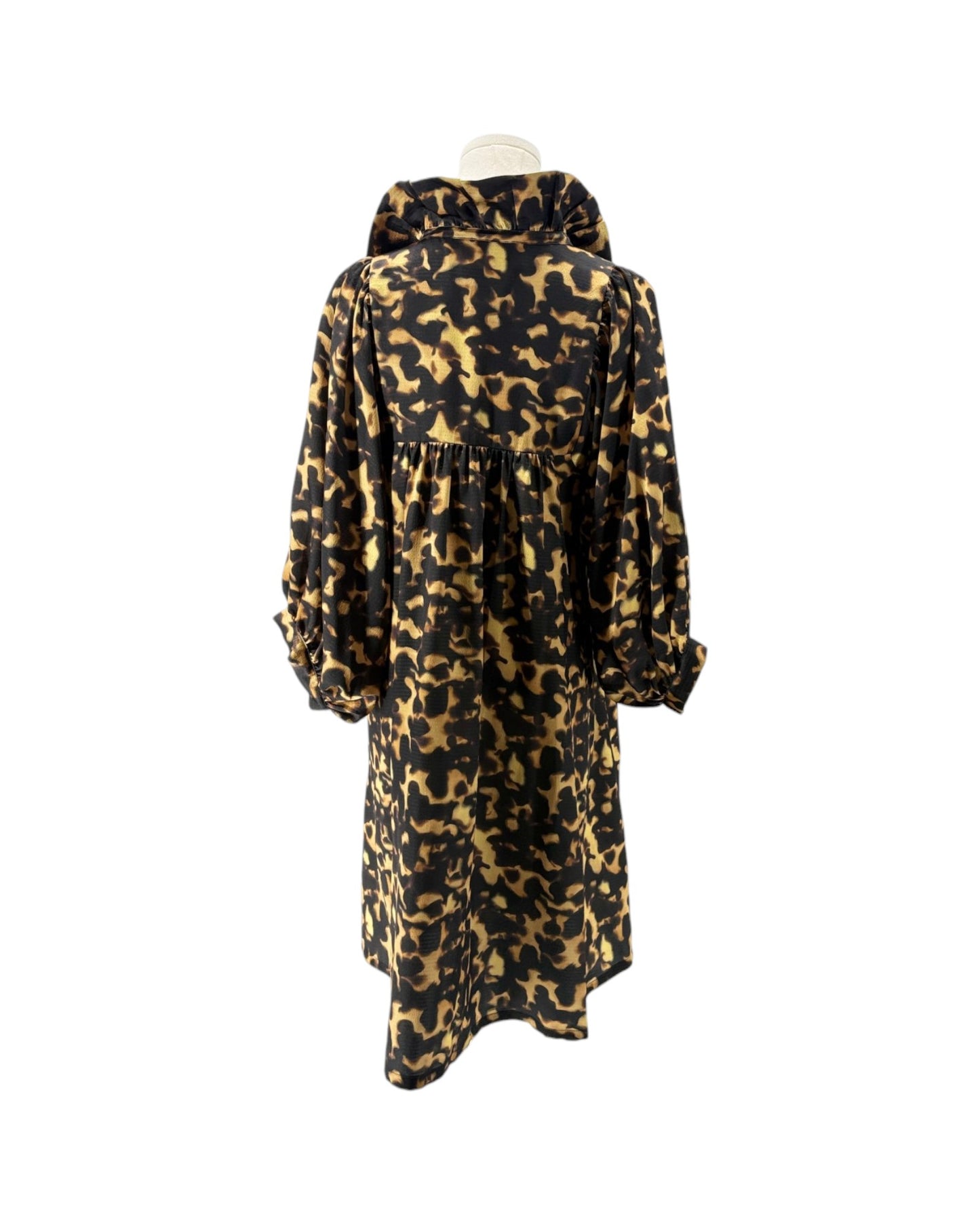 A long-sleeved hooded dress with a black and tan leopard print pattern, displayed on a mannequin against a plain white background.