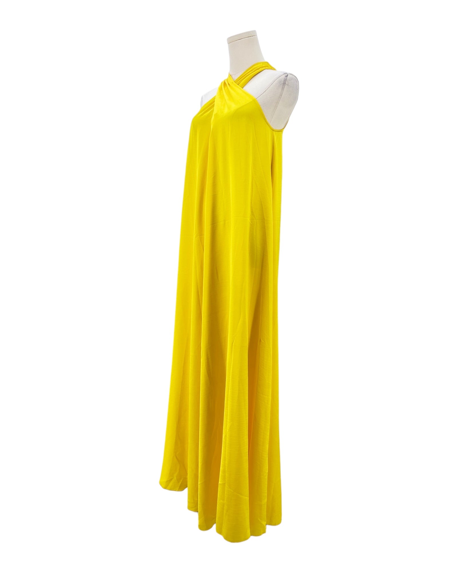 Yellow halter neck dress on a mannequin against a white background