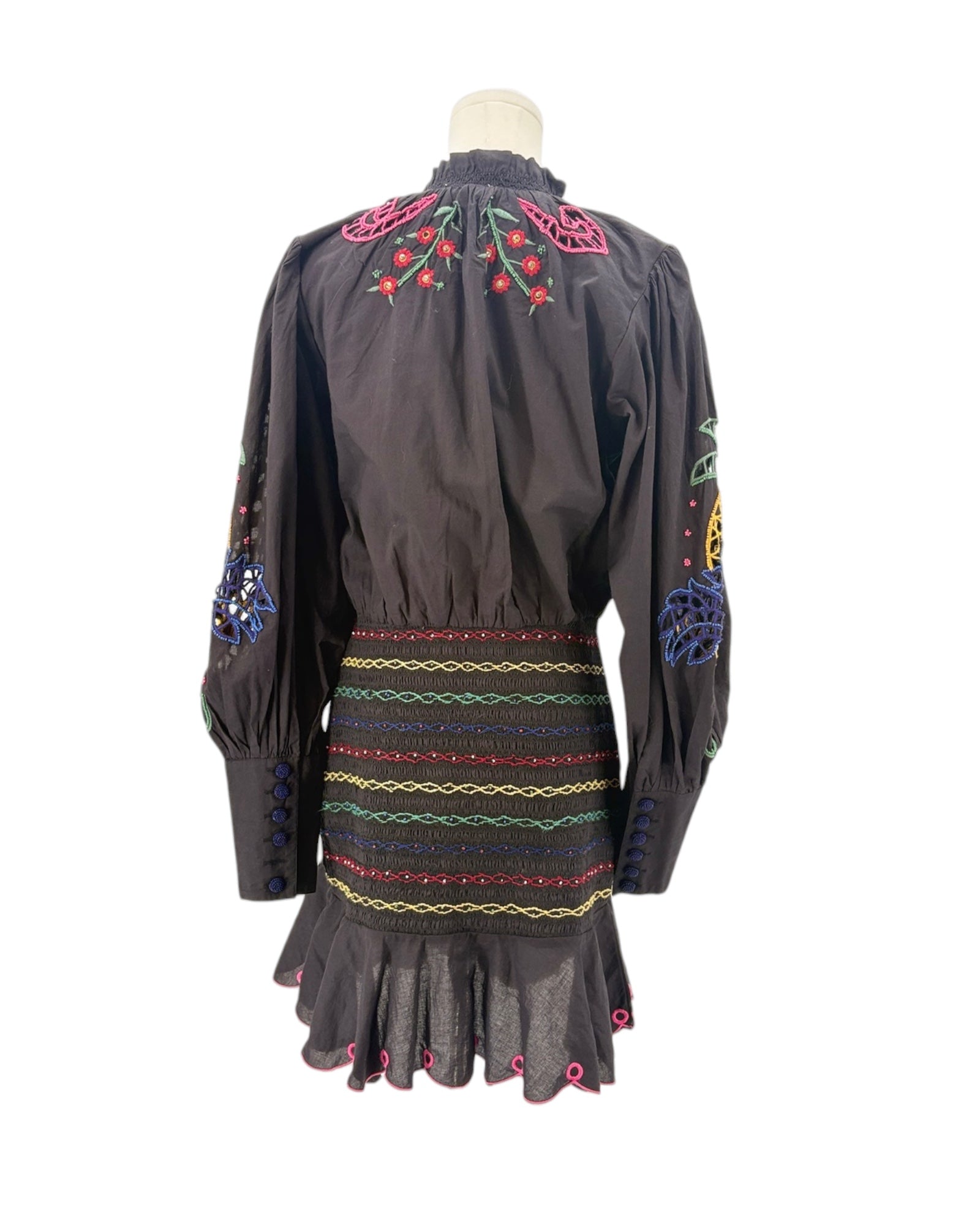 Black embroidered dress on a mannequin with a white background