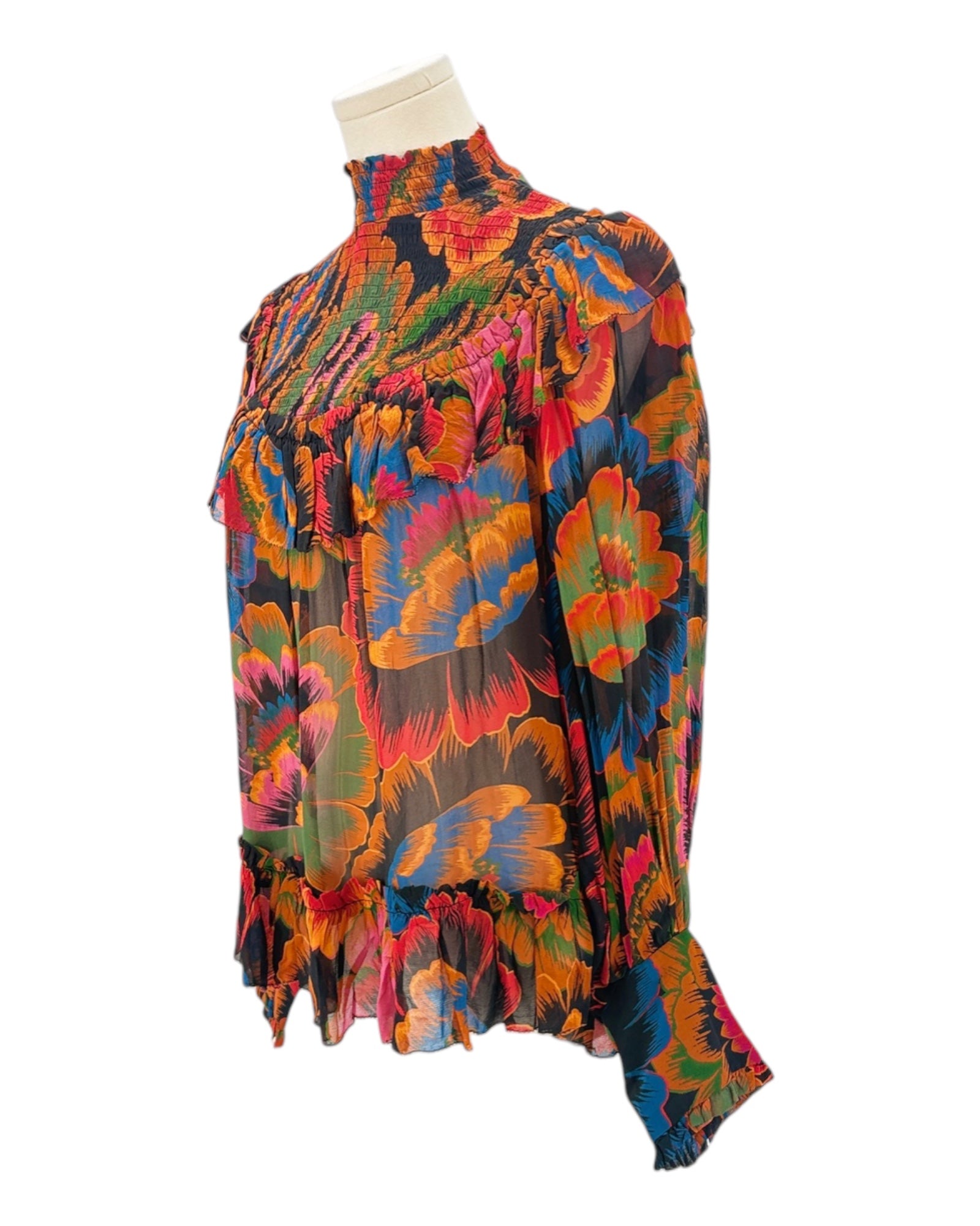Colorful floral-patterned blouse on a mannequin against a white background