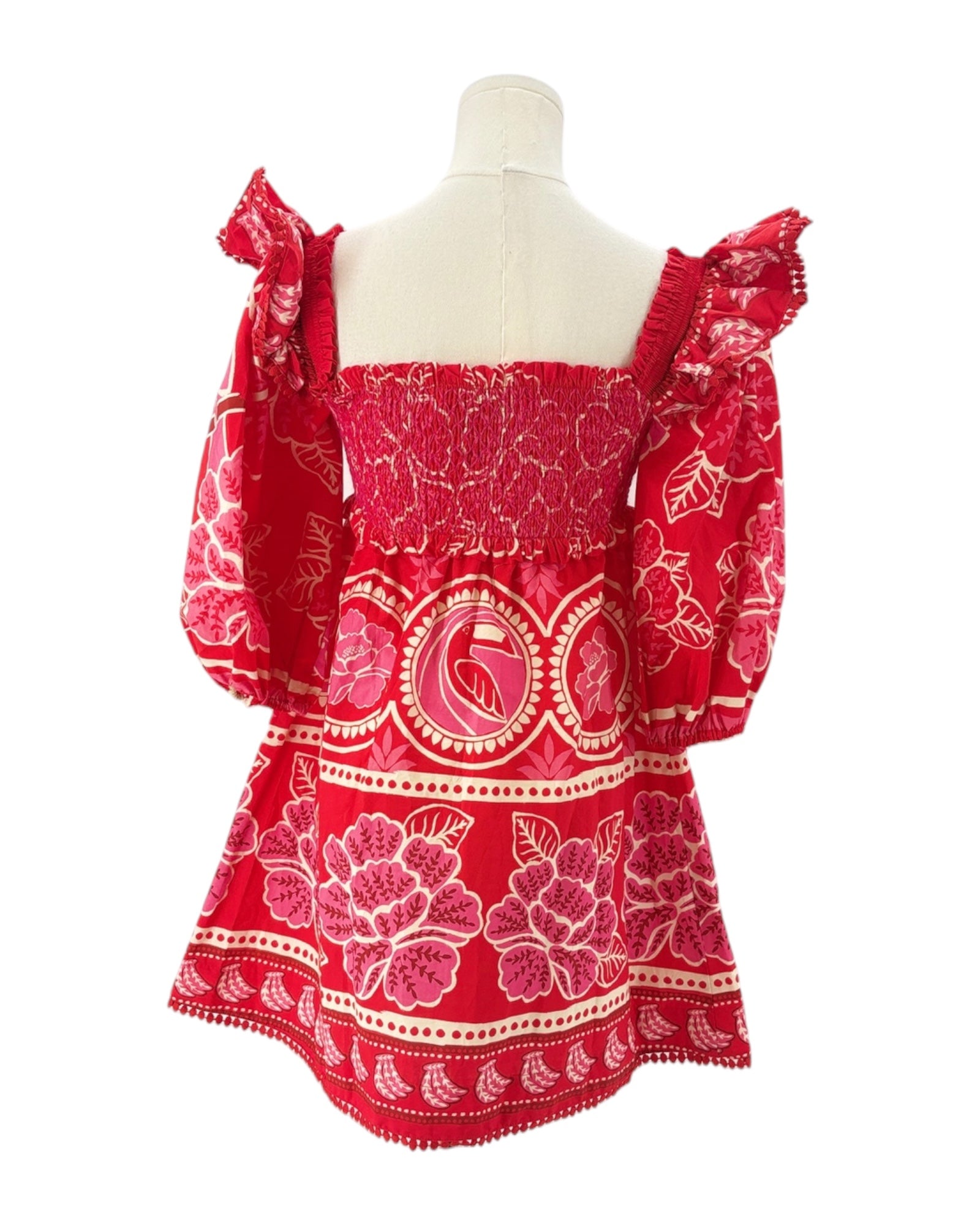 Red patterned dress on a mannequin against a white background