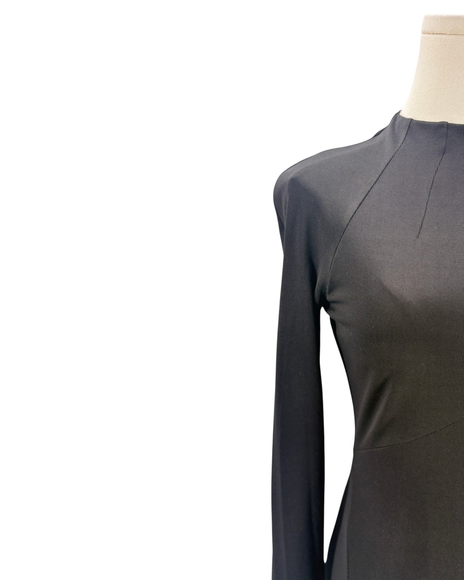 Black long-sleeve top on a mannequin against a white background