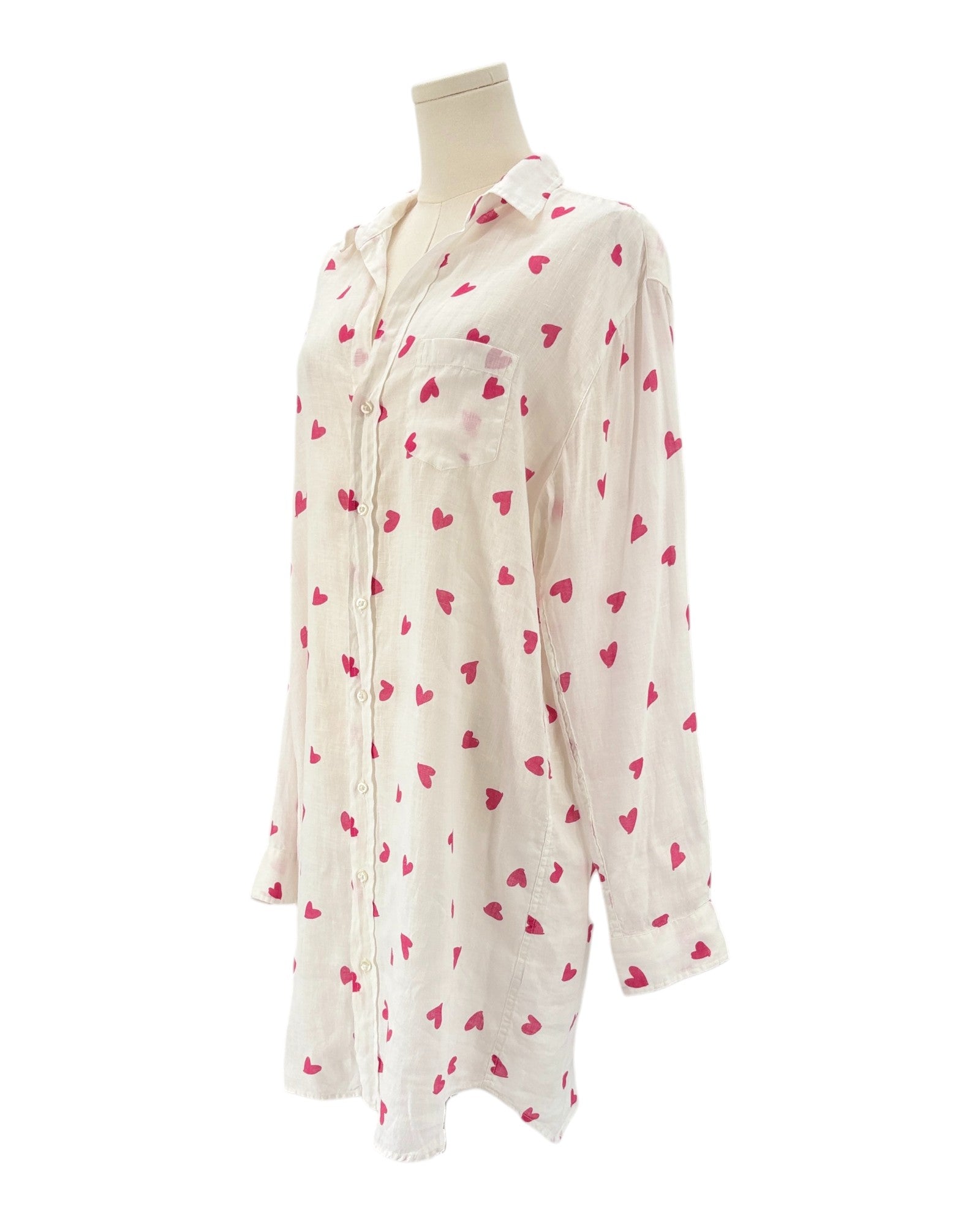xWhite shirt dress with pink heart patterns on a white background