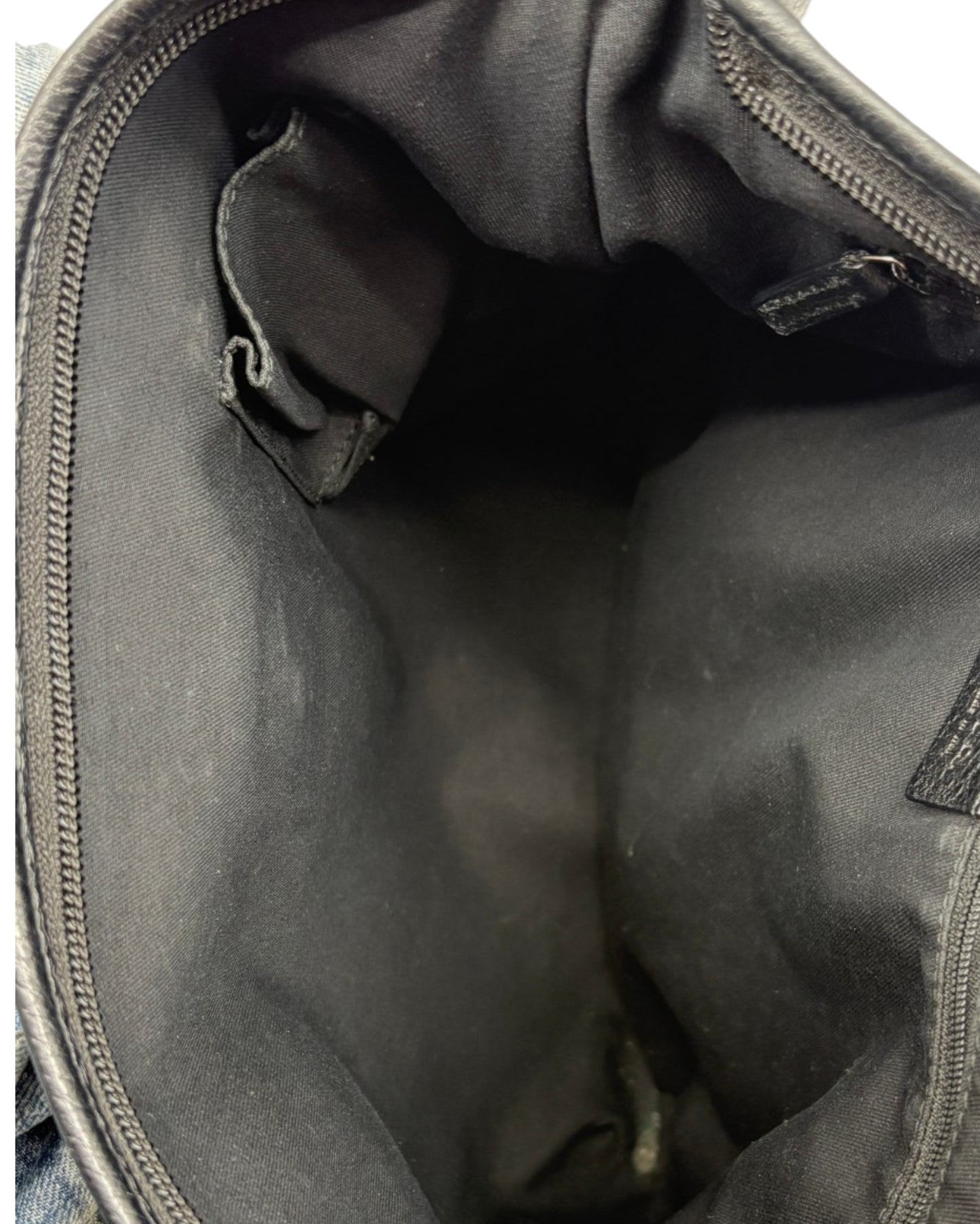 Close-up of a black bag interior with visible stitching