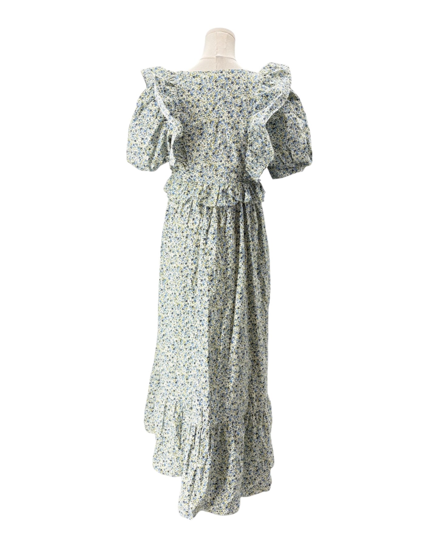 Floral dress on a mannequin against a white background