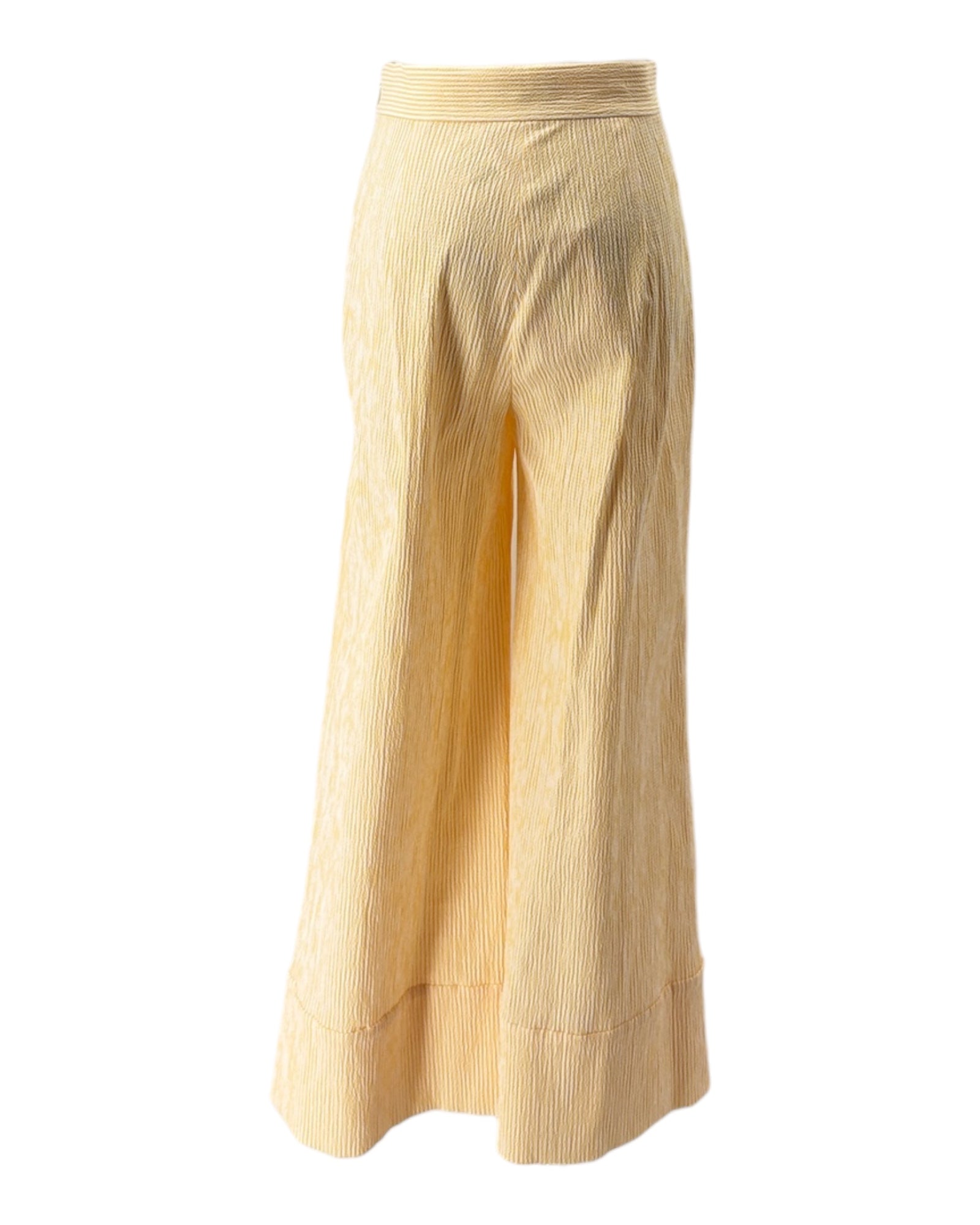 Beige and yellow ribbed pants on a white background