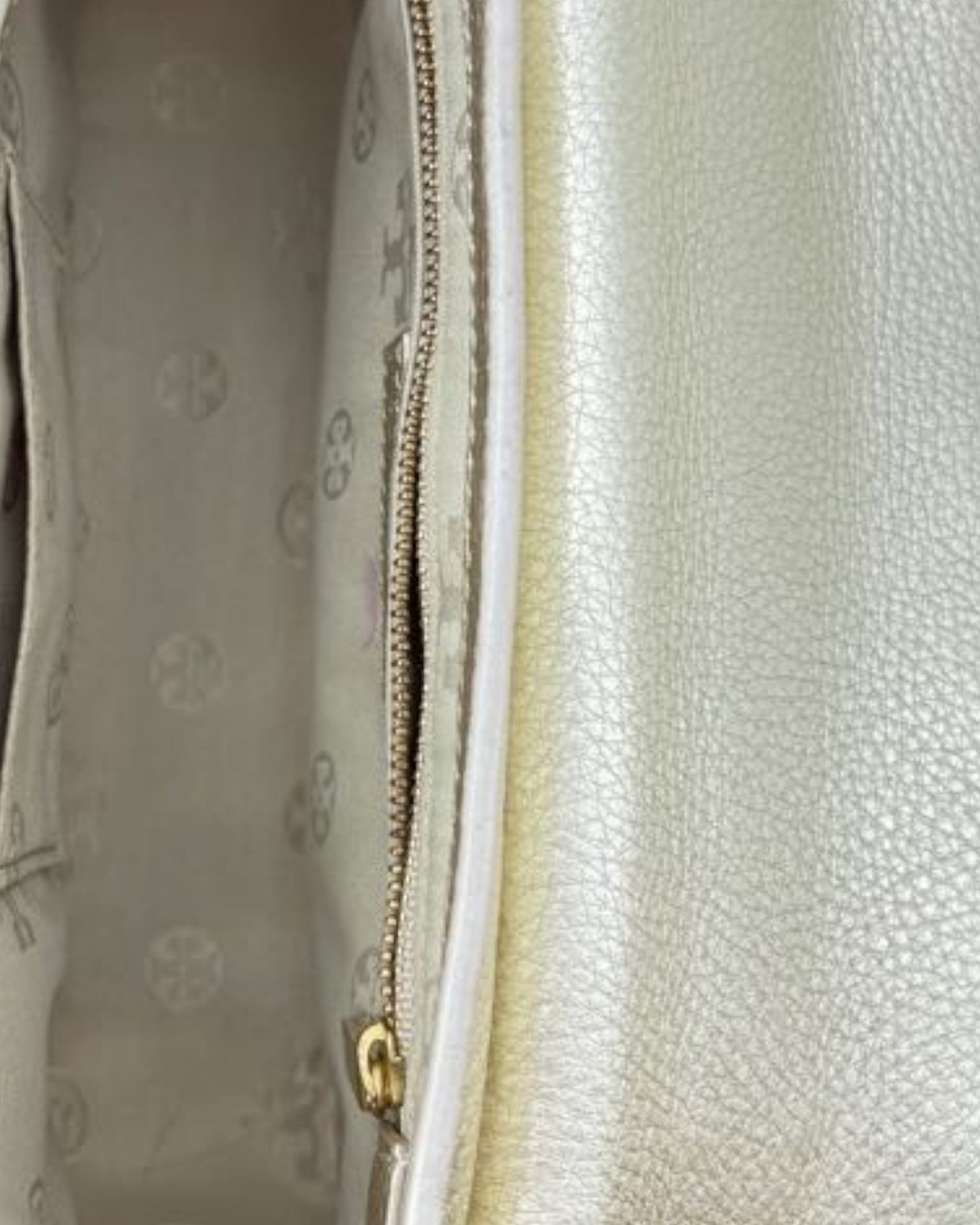 Close-up of a textured surface with a zipper and brand logo.