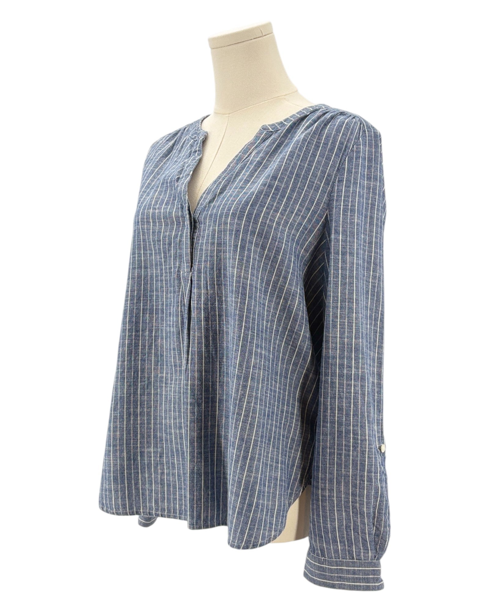 Blue and white striped shirt on a mannequin against a white background