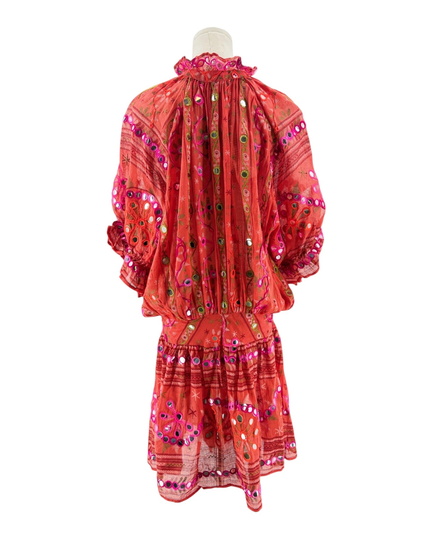 Red embroidered dress on a mannequin against a white background