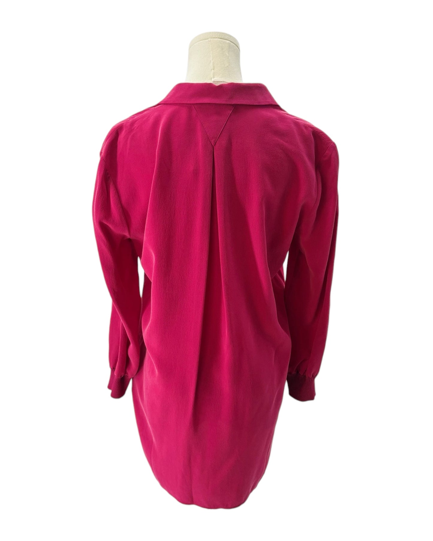 Pink dress on a mannequin against a white background