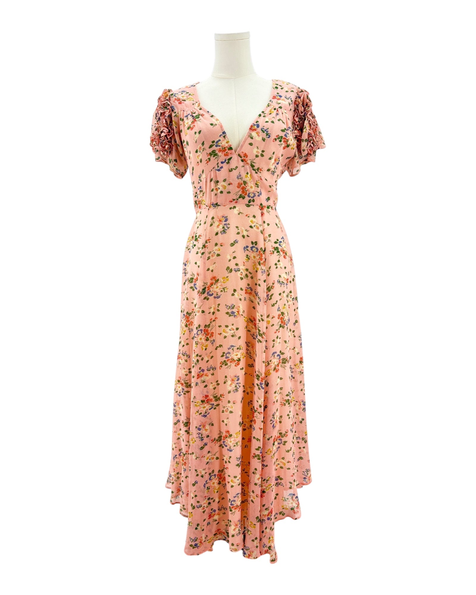Floral dress on a mannequin against a white background
