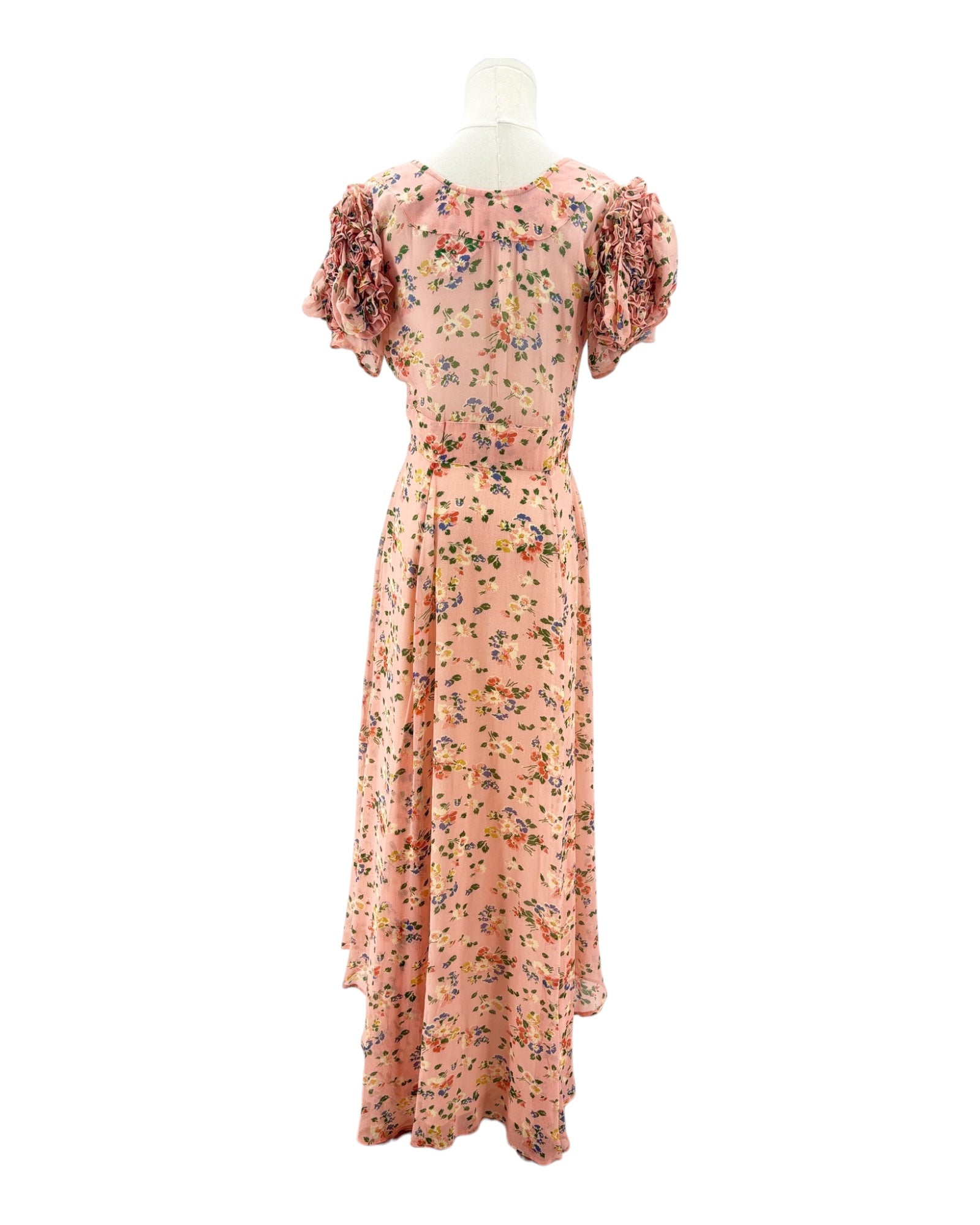 Floral dress on a mannequin against a white background