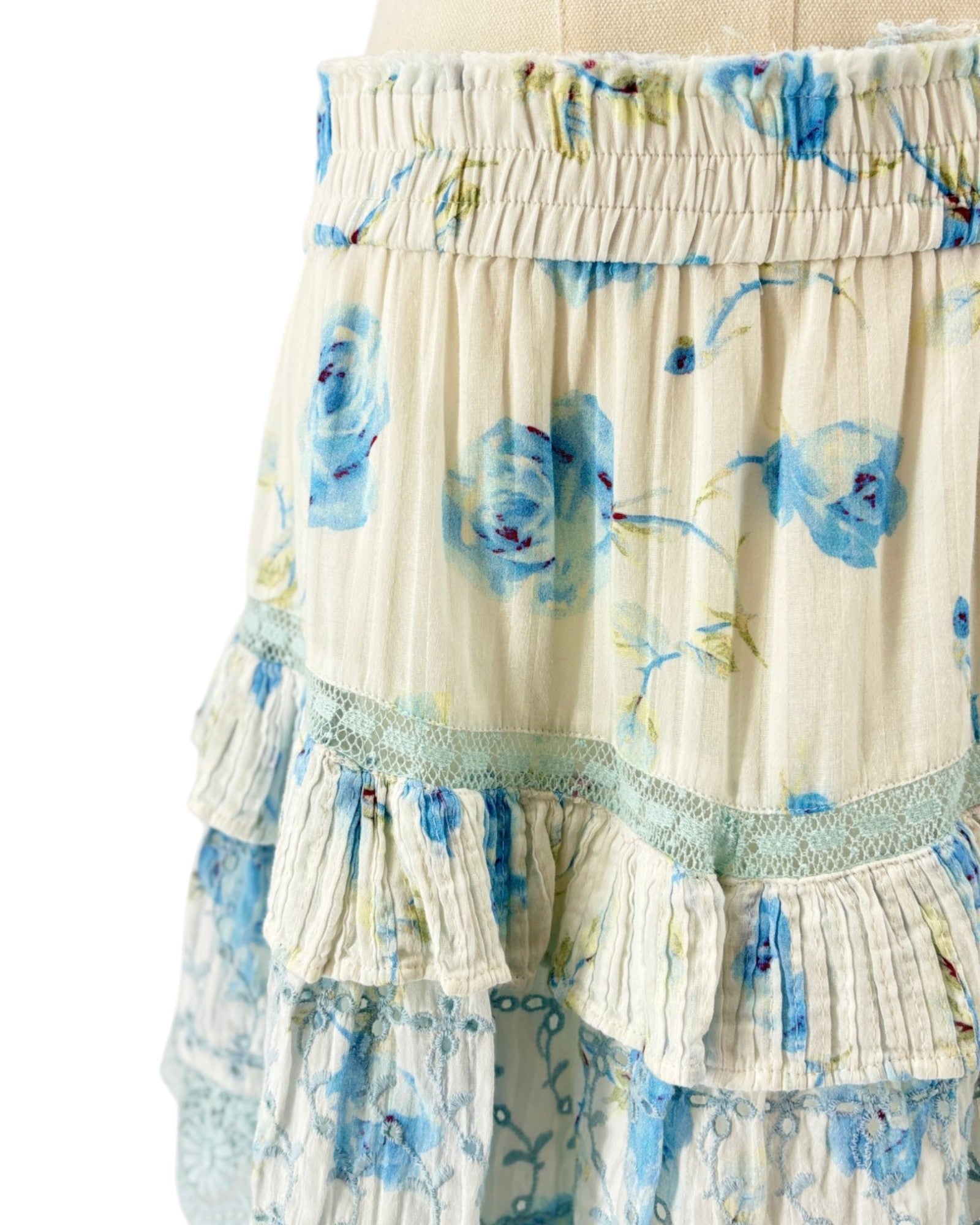 Loveshackfancy floral tiered mini skirt with blue flowers on a white background