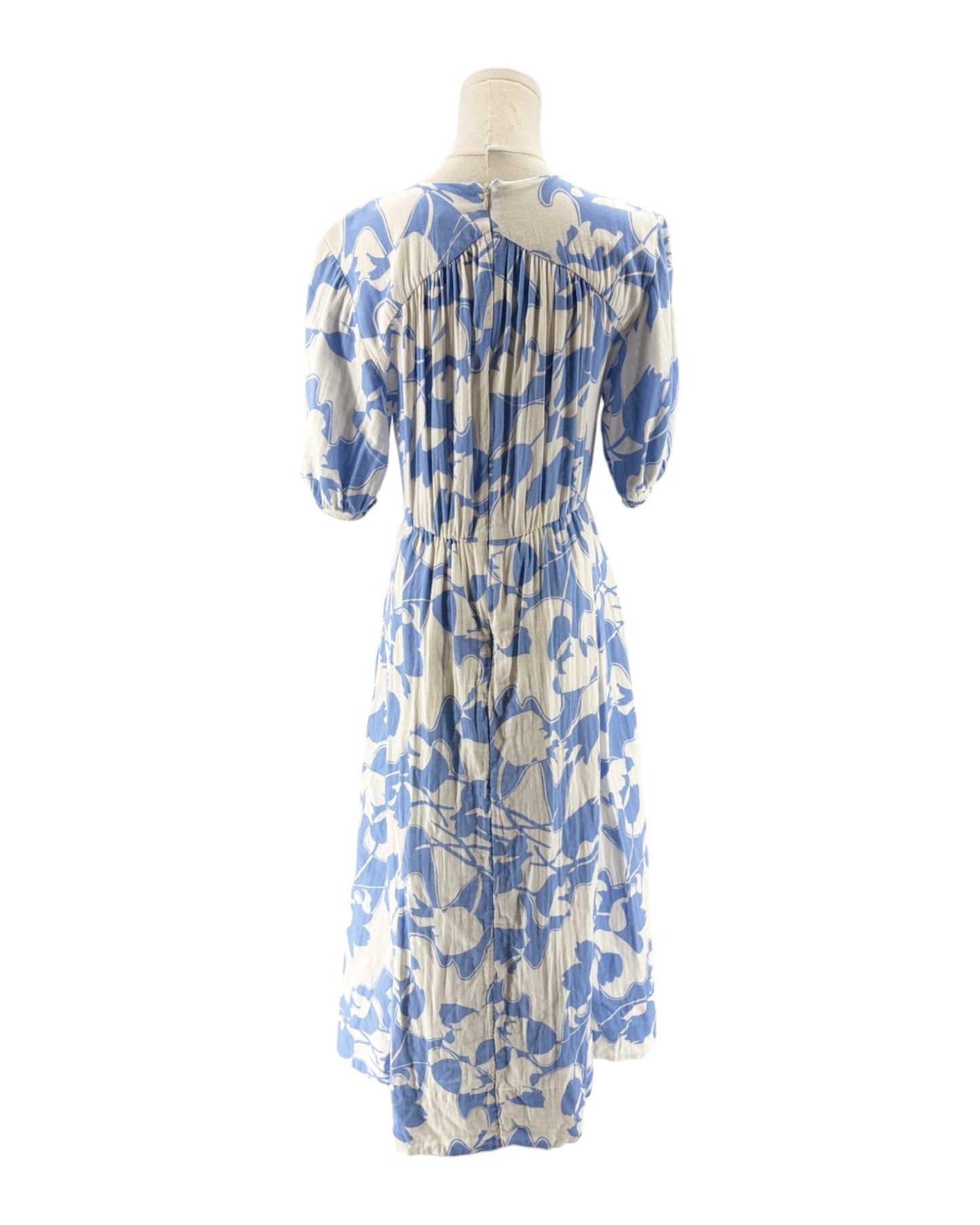 Blue and white floral dress on a mannequin against a white background