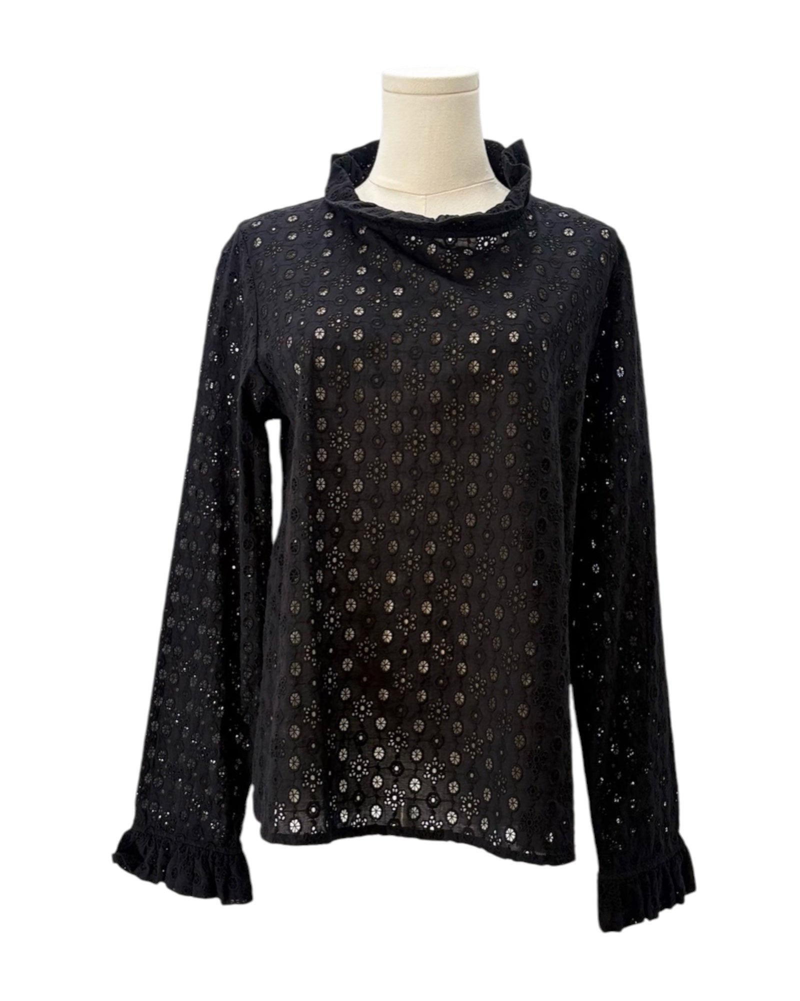Black long-sleeve top with sequin details on a mannequin against a white background