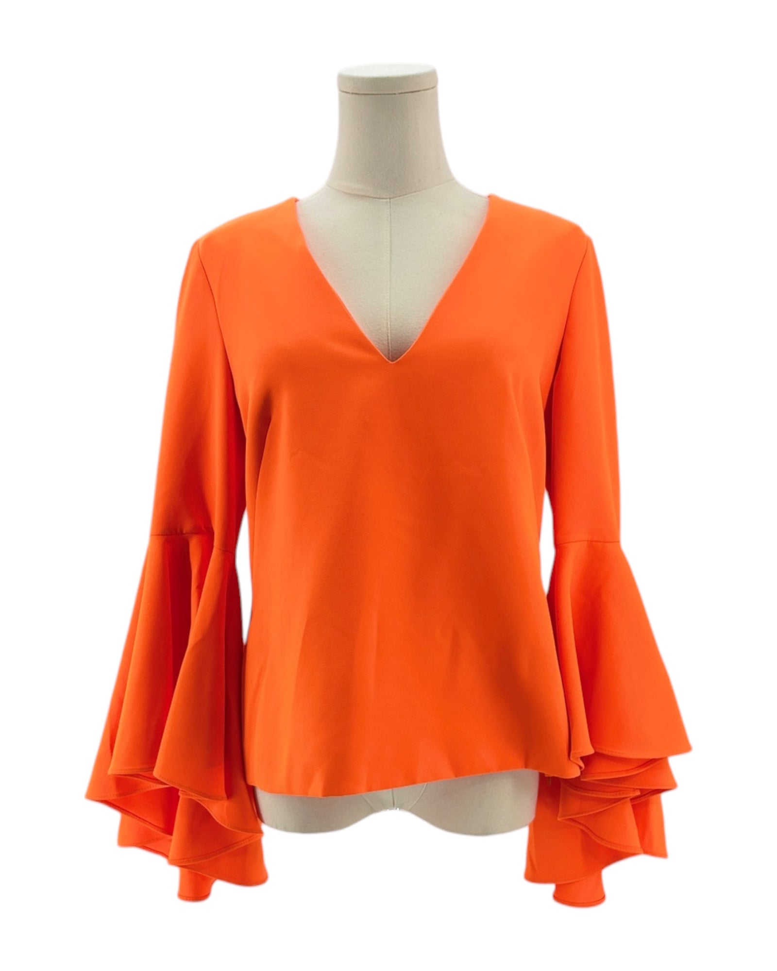 Orange blouse with ruffled sleeves on a mannequin against a white background