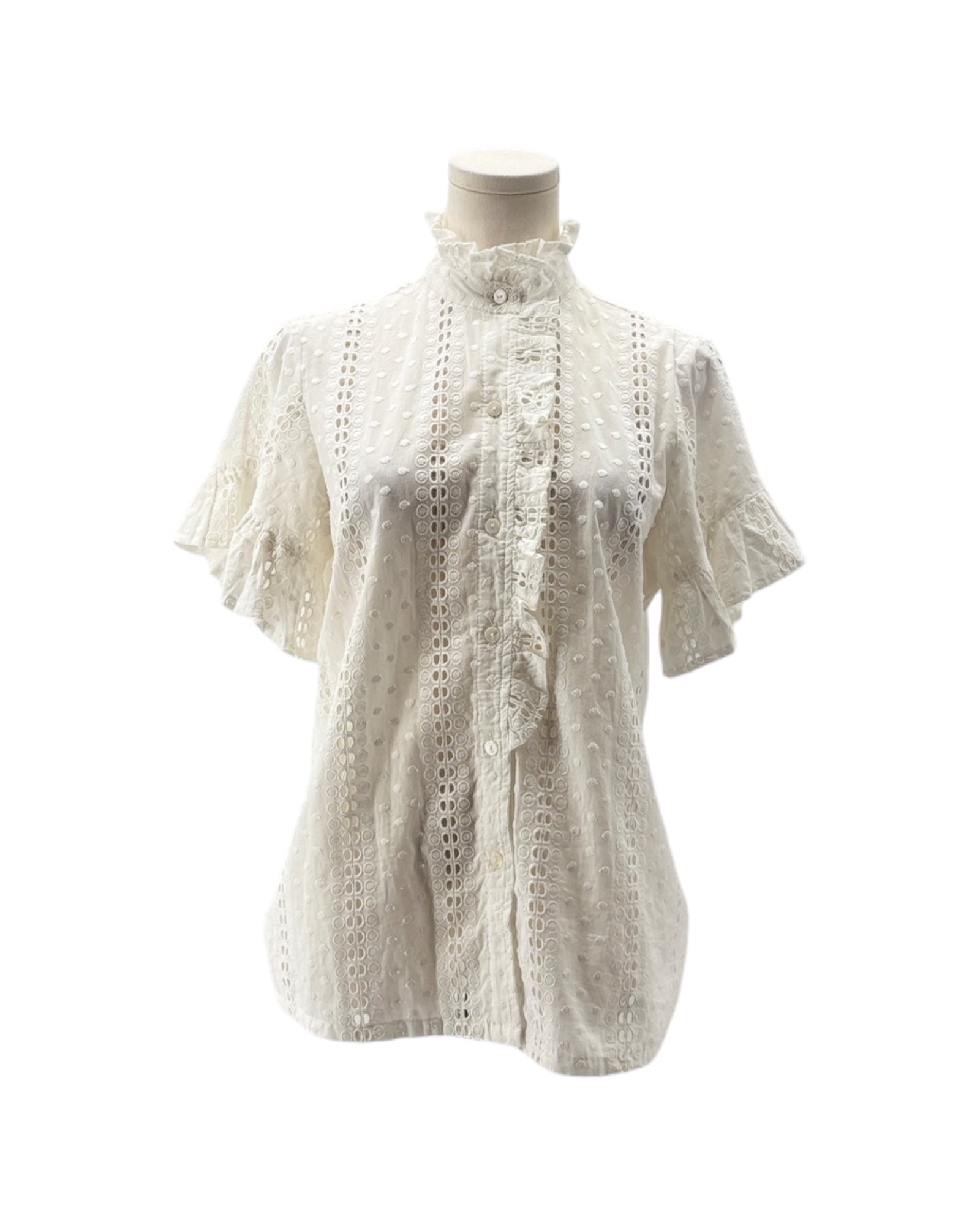 White lace blouse on a mannequin against a white background