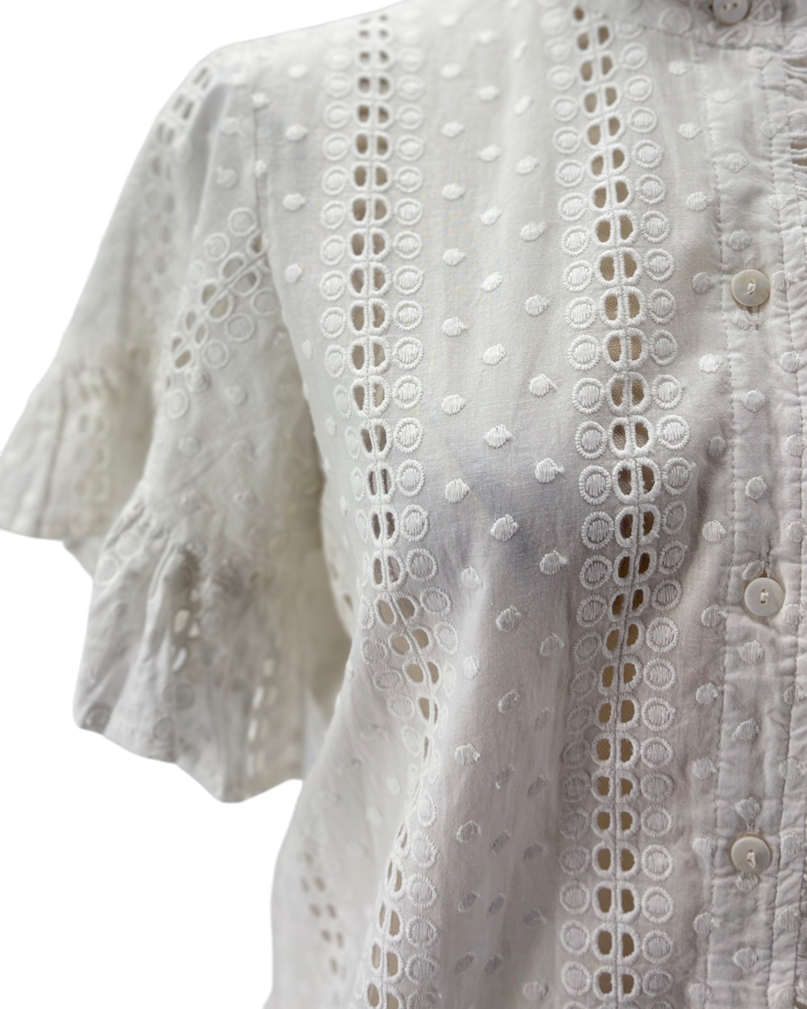 White lace blouse with button details on a white background