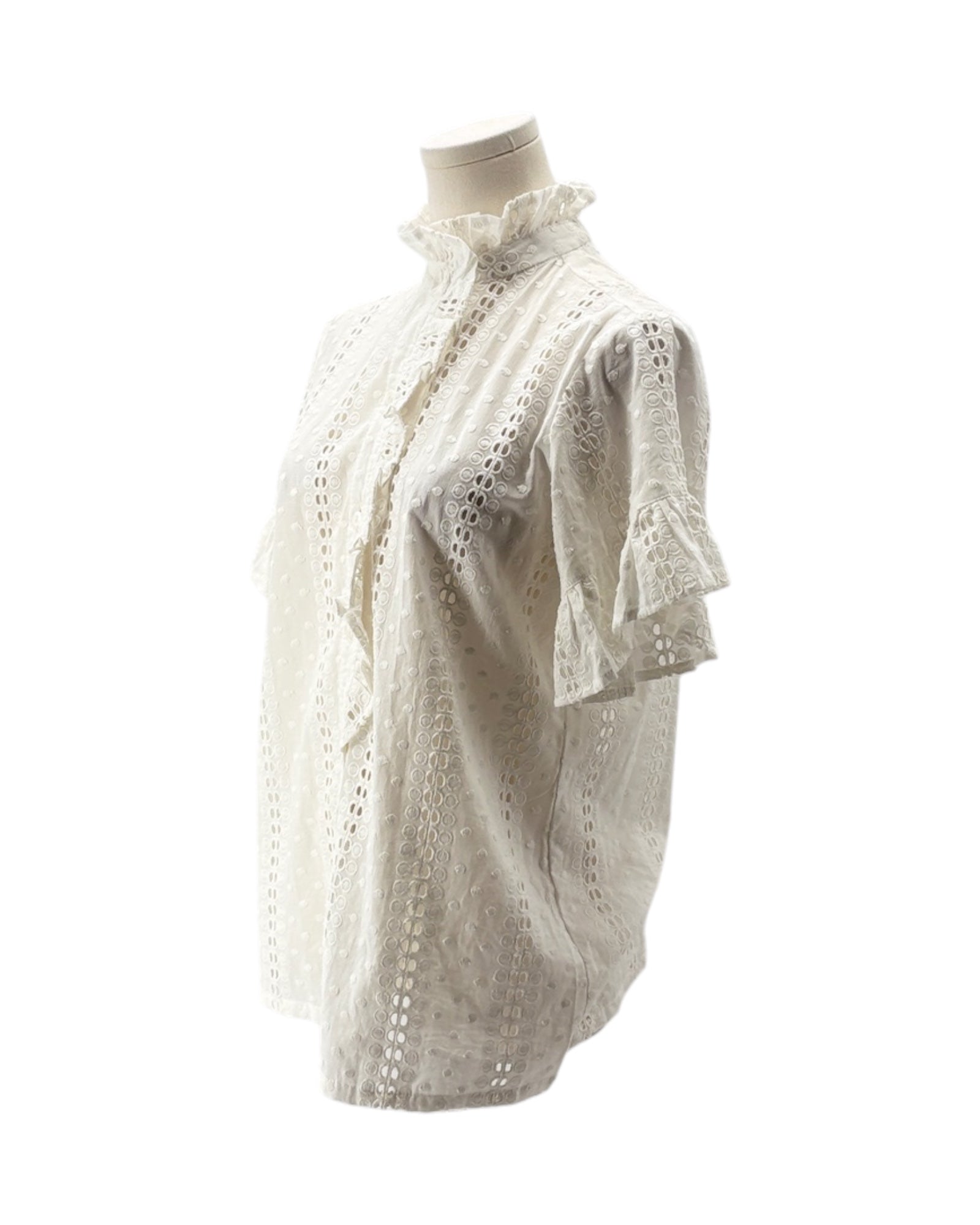 White lace blouse on a mannequin against a white background