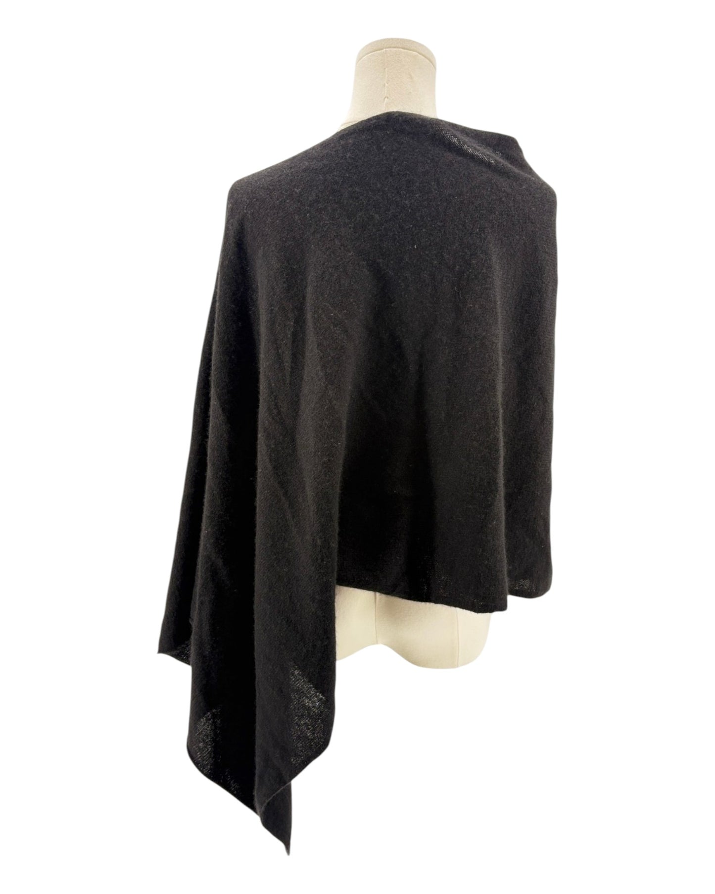 Black poncho on a mannequin against a white background