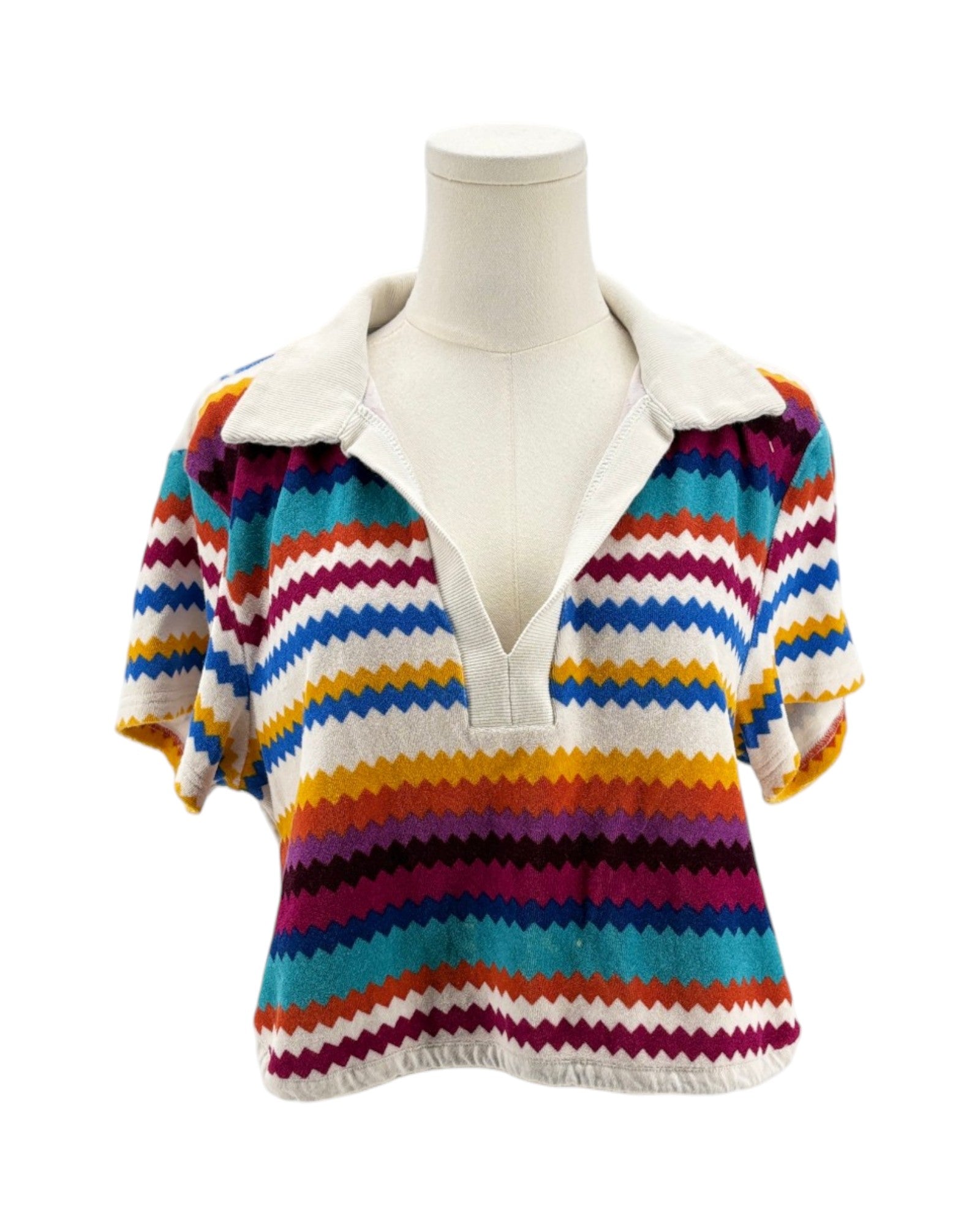 Colorful striped sweater on a mannequin against a white background
