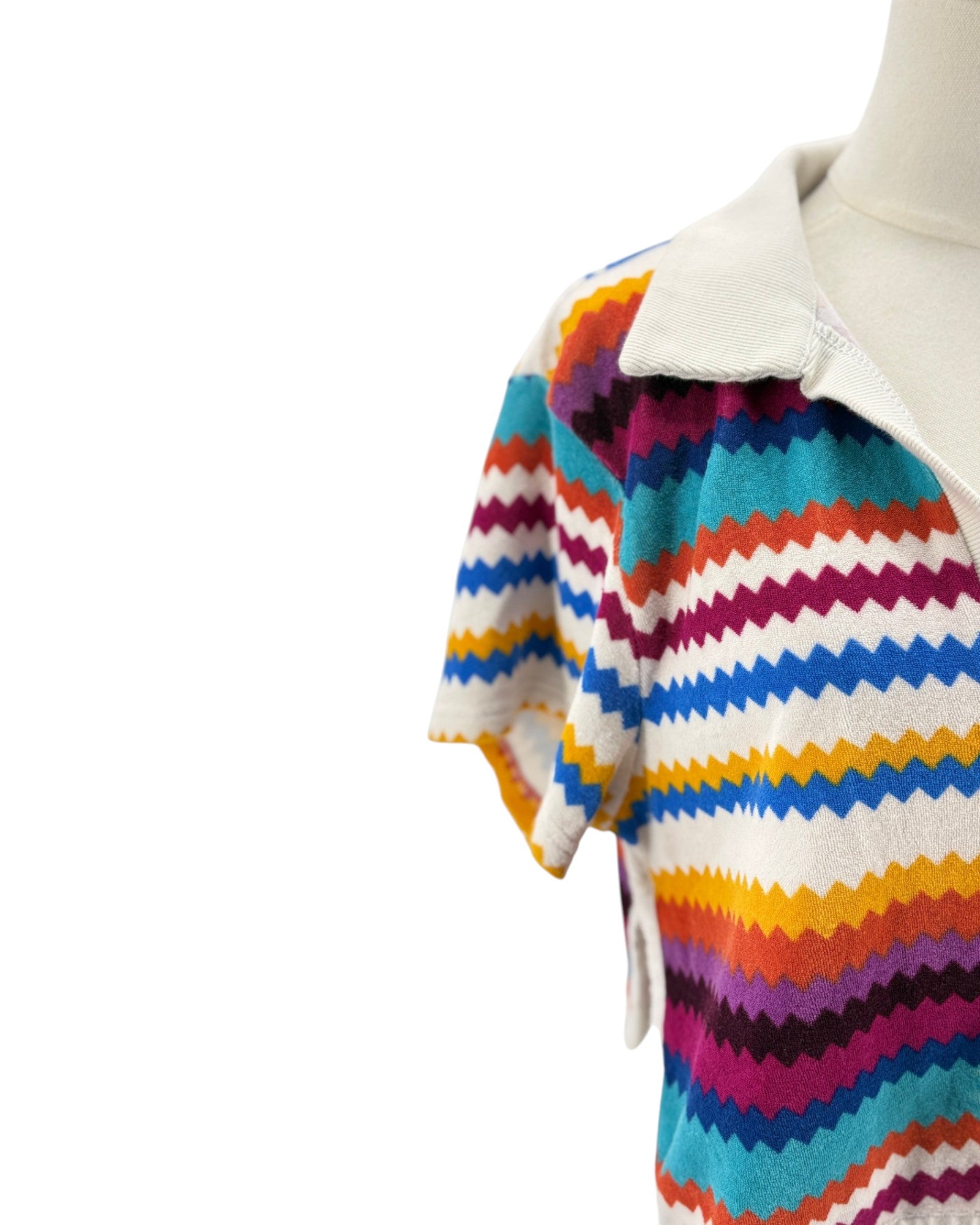 Colorful striped sweater on a mannequin against a white background